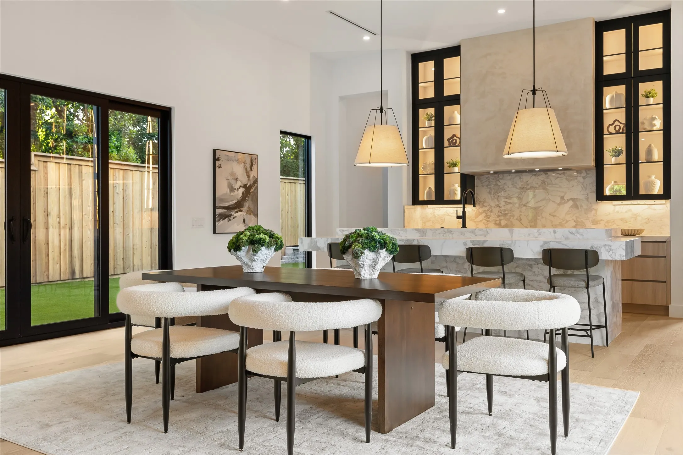 Open-concept dining area featuring light wood-finish flooring