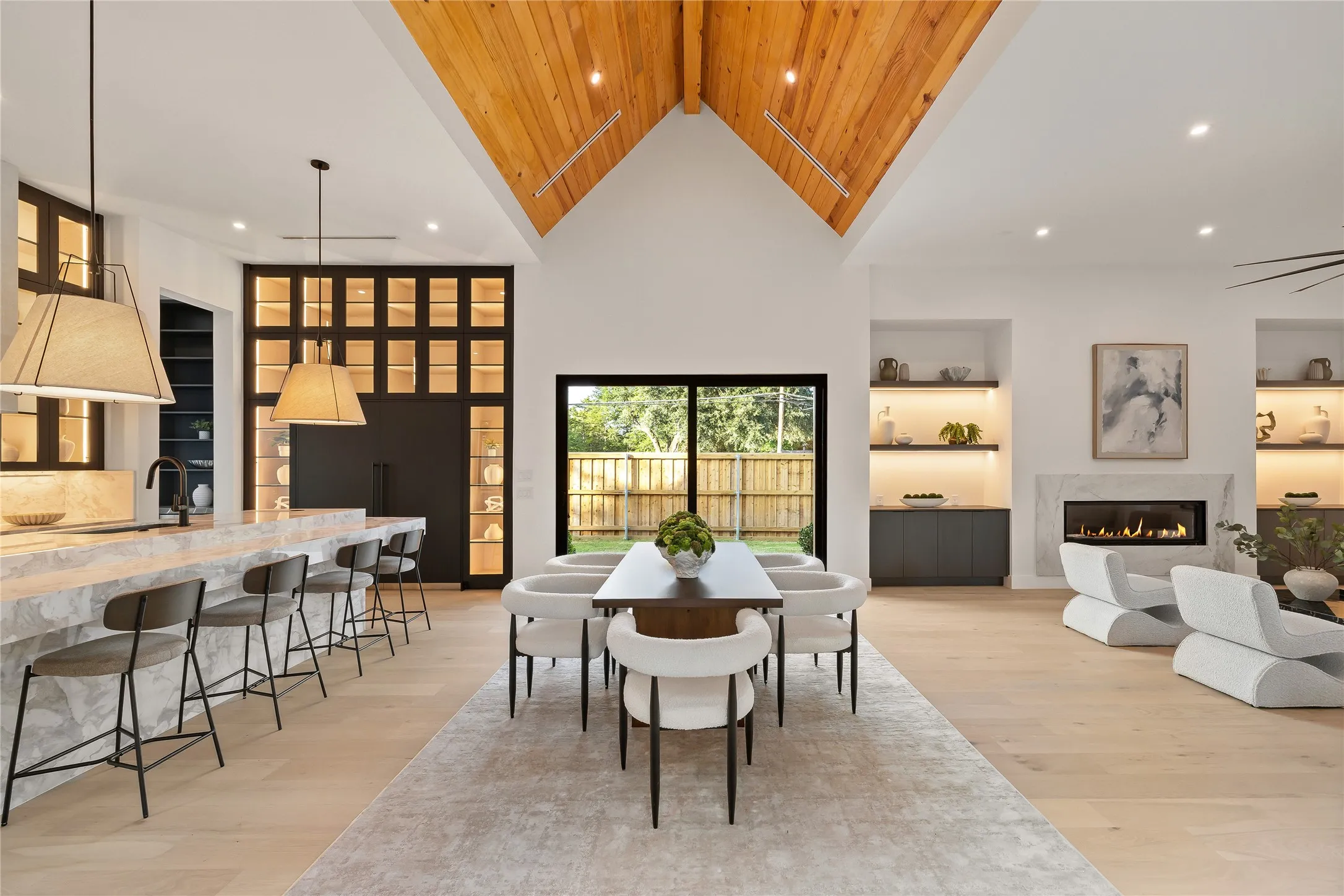 Vaulted wood-paneled ceiling highlights this open-concept living space