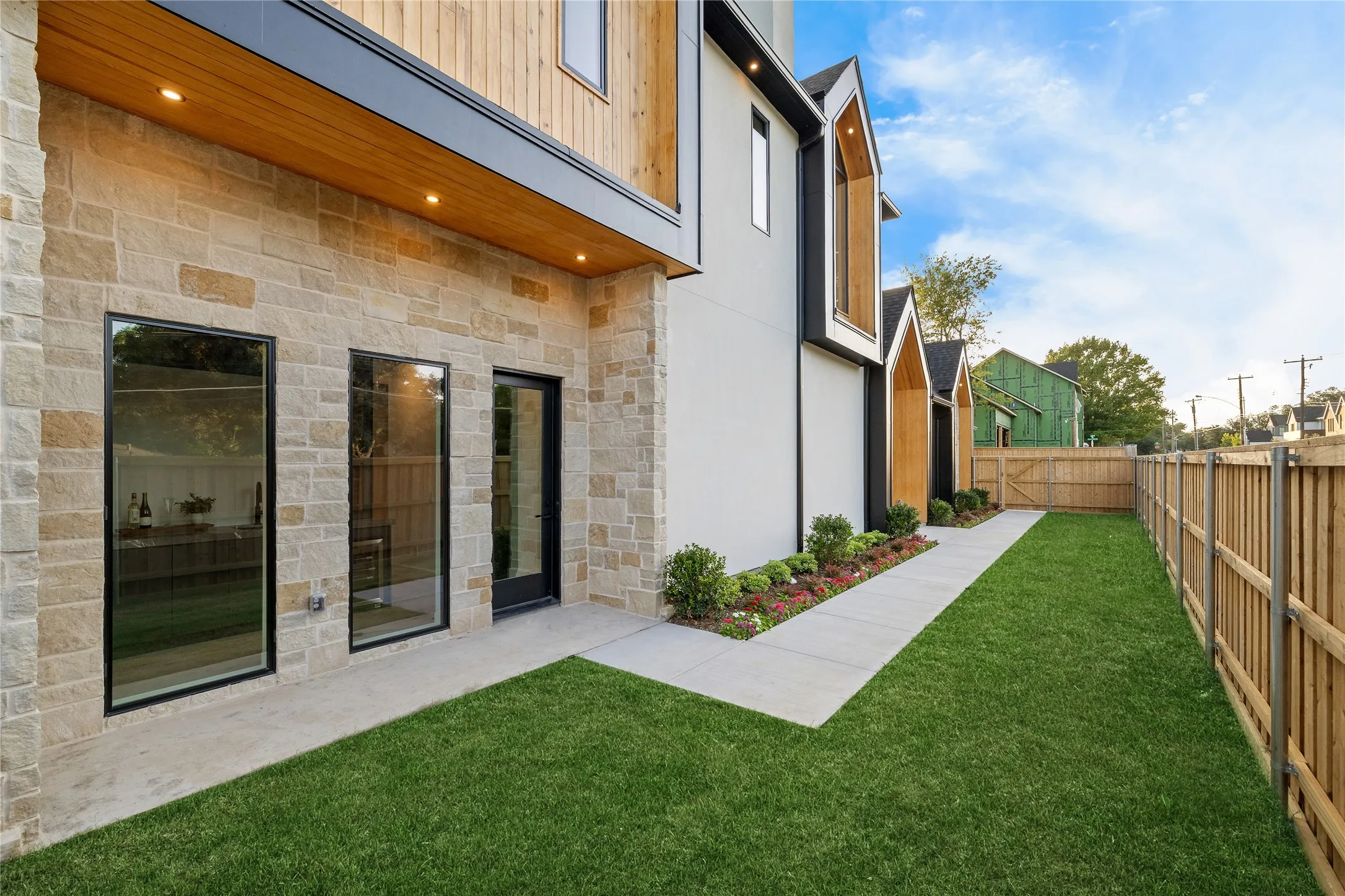 Expansive green lawn with a privacy fence