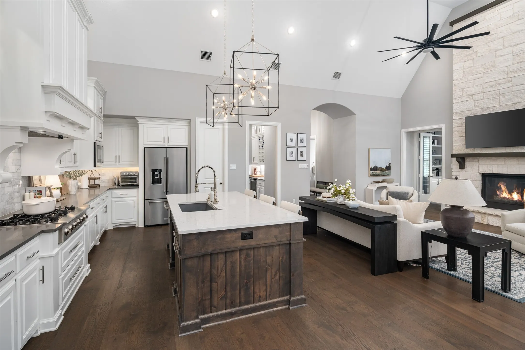 Experience seamless open-concept living where the kitchen, family room, and dining area come together beneath soaring vaulted ceilings. Designed for both comfortable everyday living and effortless entertaining, this exceptional gathering space offers the perfect blend of luxury and functionality.