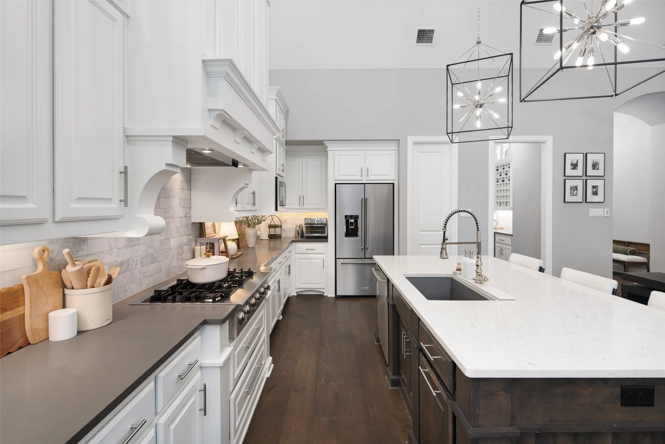 Designed for both beauty and functionality, the chef's kitchen is appointed with premium stainless steel appliances, including double ovens and a professional six-burner gas cooktop beneath a custom vent hood.