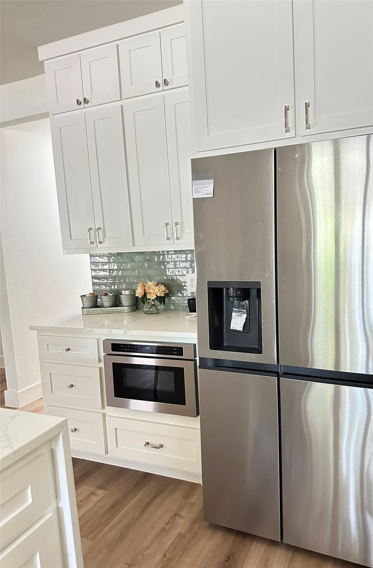 Refrigerator makes round large ice balls and regular sized! Sits next to coffee bar.