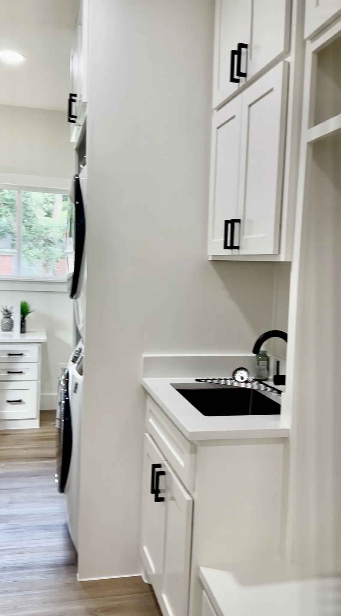 Mud room with, full size w/d, sink, drop zone & built in corner desk.