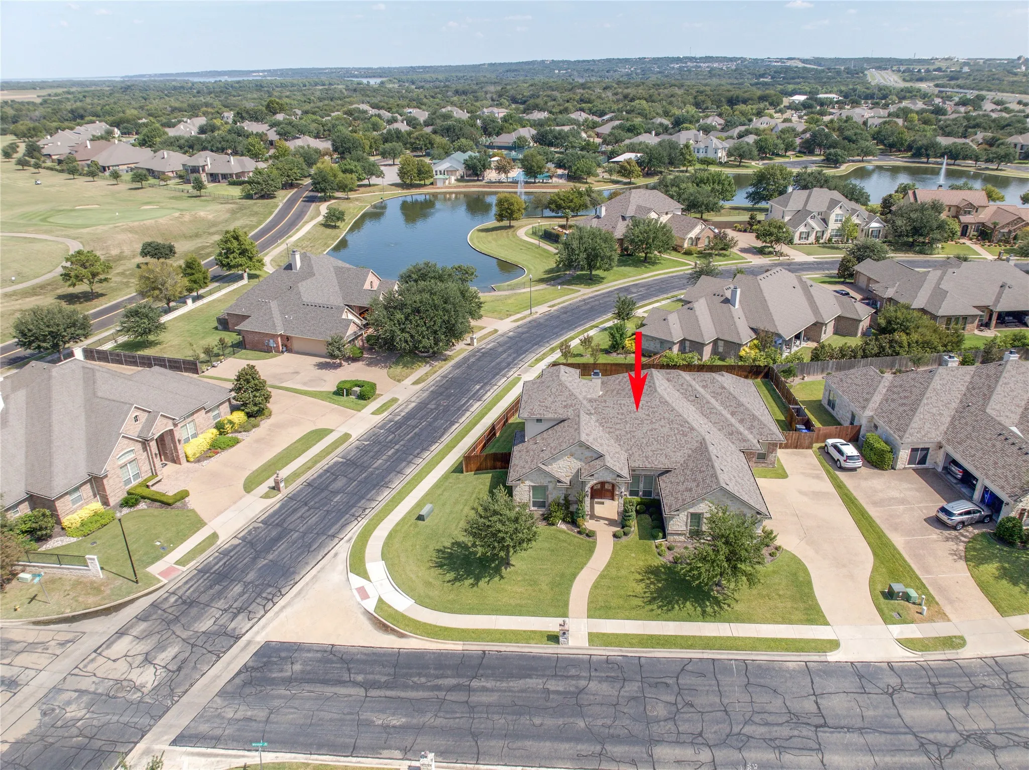 Aerial overview of a residential property featuring a stone and brick exterior
