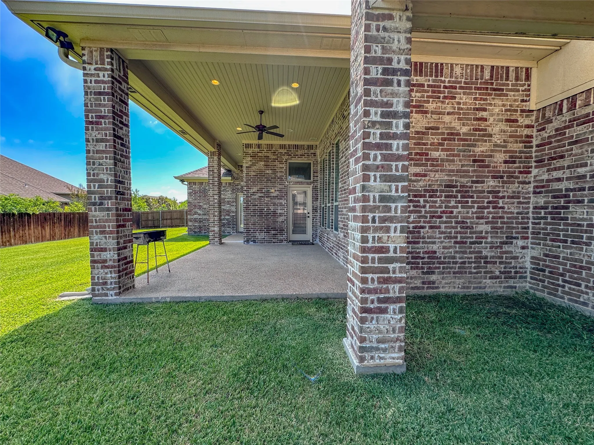 Covered patio featuring brick pillars, an outdoor ceiling fan, recessed lighting, and a concrete​​‌​​​​‌​​‌‌​‌‌​​​‌‌​‌​‌​‌​​​‌​​ slab