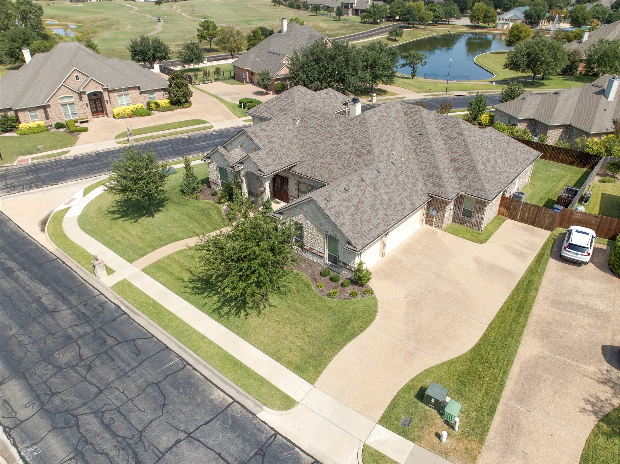 Expansive residential property featuring a stone and brick exterior with a multi-gabled roofline