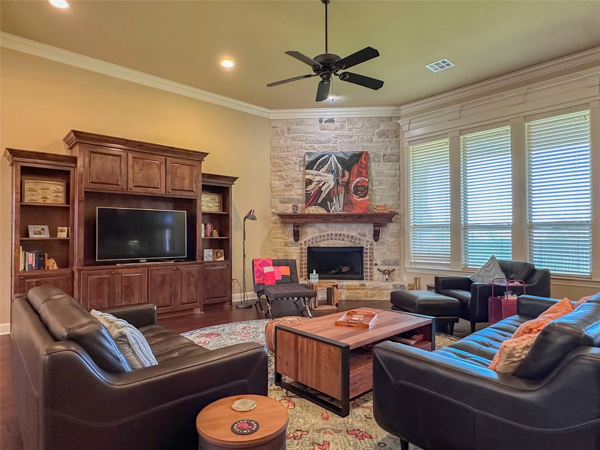 Living area with a stone-clad fireplace and wood mantel