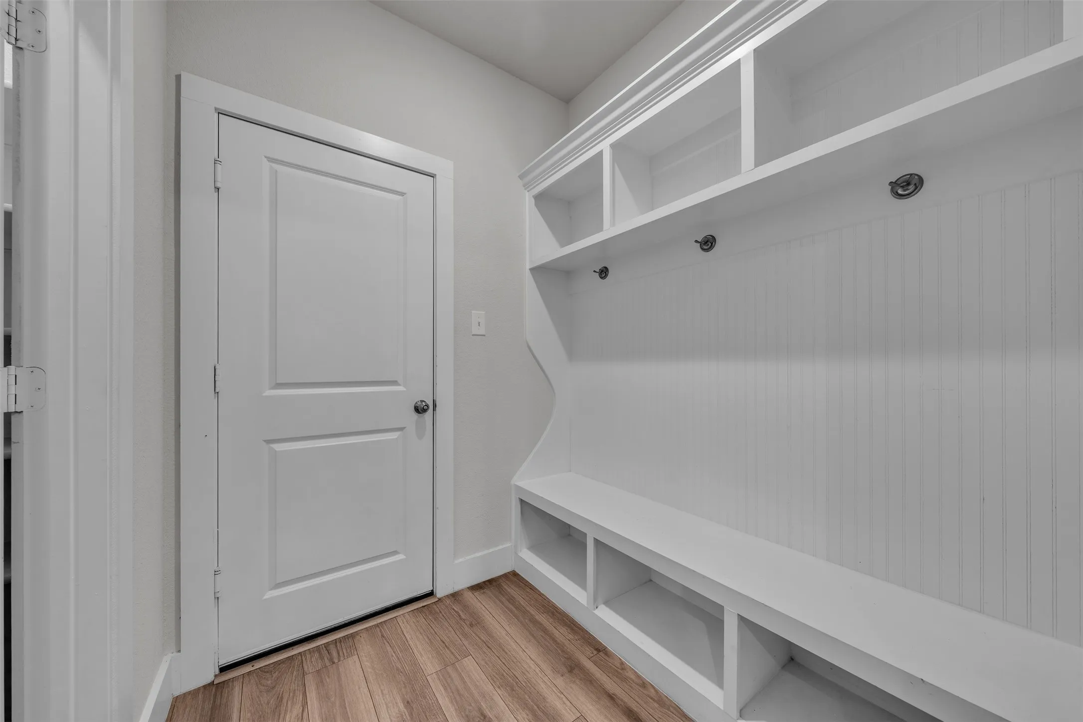 Mud Room at 5149 Cantle Ct in Fort Worth, Texas, Tarrant County, coming in from garage with hooks and shelving for storage of personal items.