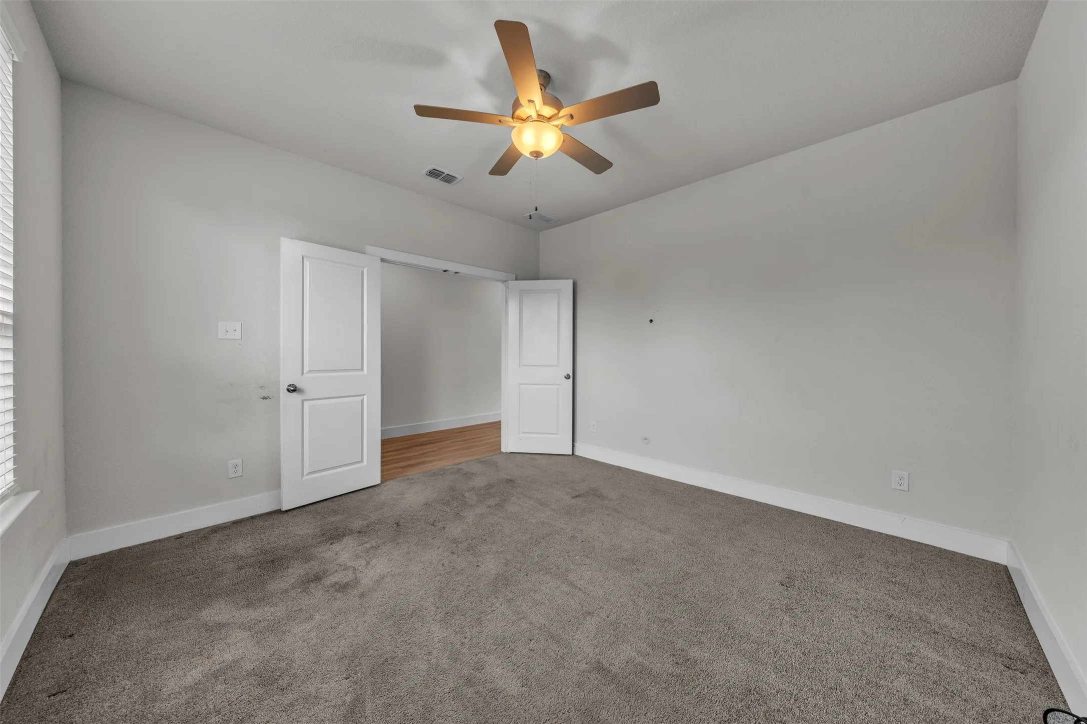 Office at 5149 Cantle Ct in Fort Worth, Texas, Tarrant County, with double door entry, ceiling fan, and natural light. This is a dedicated office space.