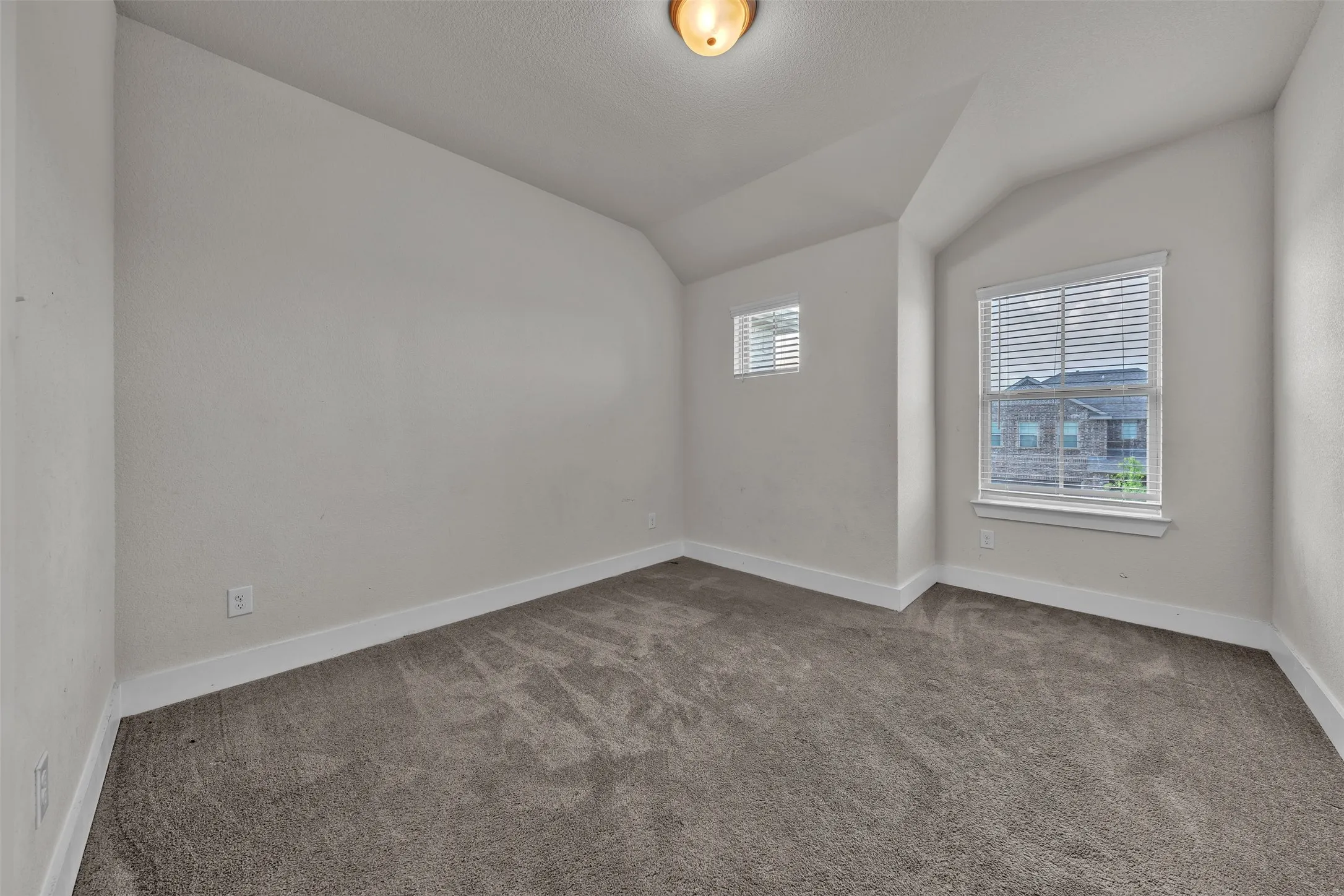 Bedroom 2 at 5149 Cantle Ct in Fort Worth, Texas, Tarrant County, with light colored carpet facing large windows allowing natural light. Located on second floor.