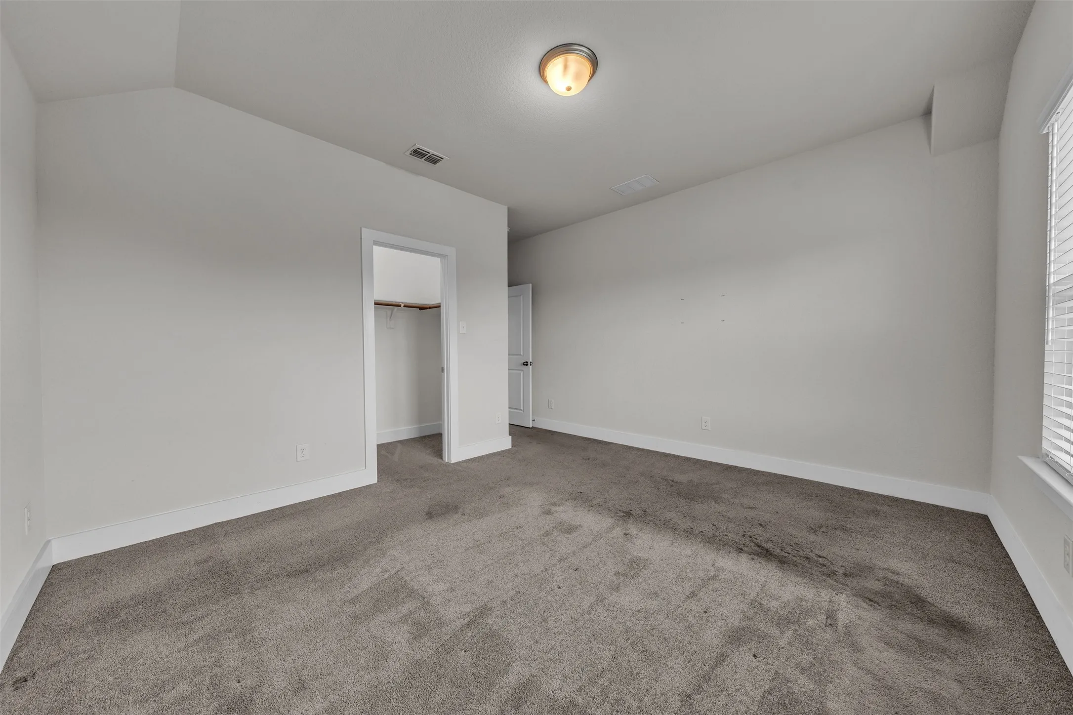 Bedroom 3 at 5149 Cantle Ct in Fort Worth, Texas, Tarrant County, with light colored carpet facing large windows allowing natural light. Located on second floor.