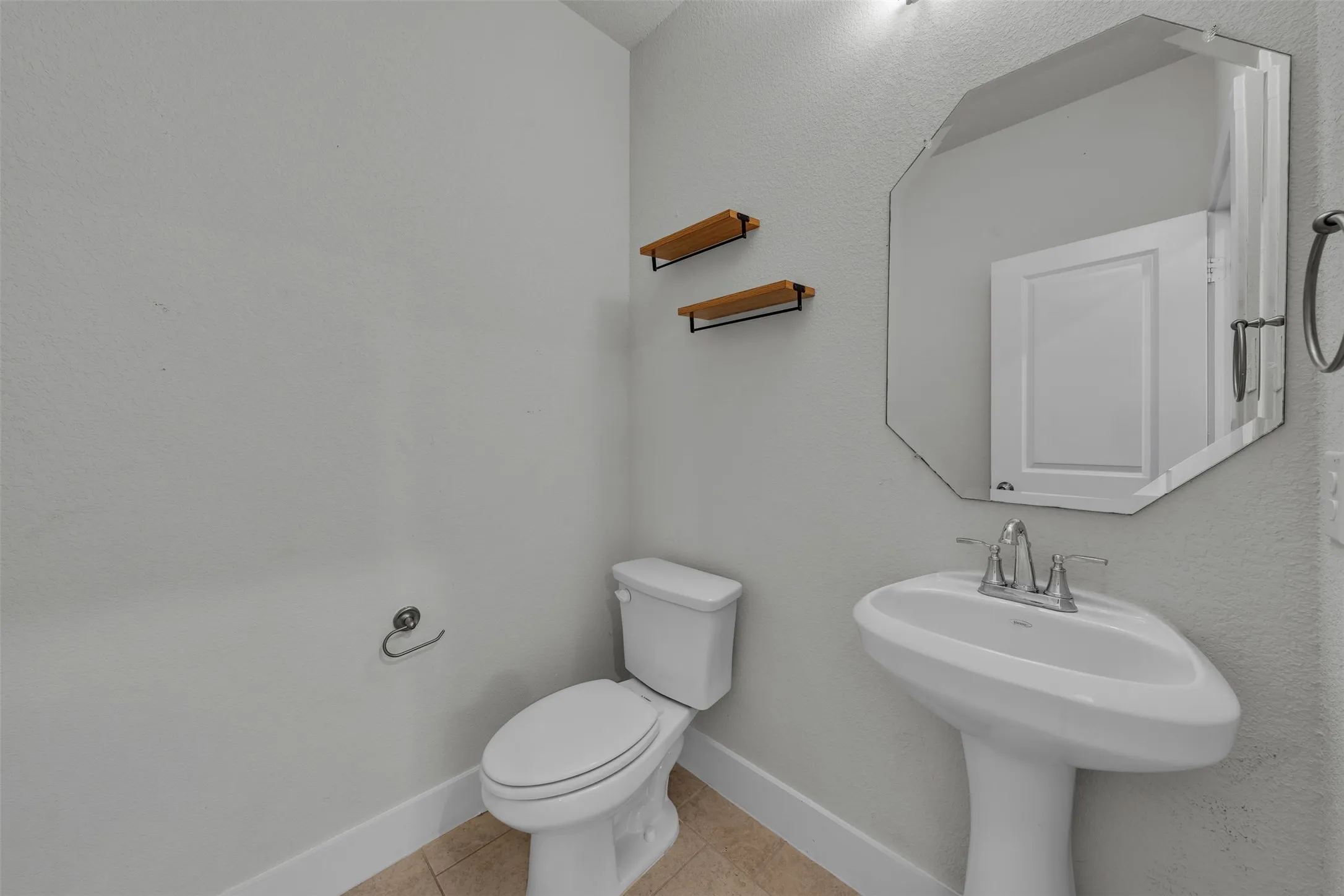 Half bathroom at 5149 Cantle Ct in Fort Worth, Texas, Tarrant County, located downstairs for easy guest access with a pedestal sink.