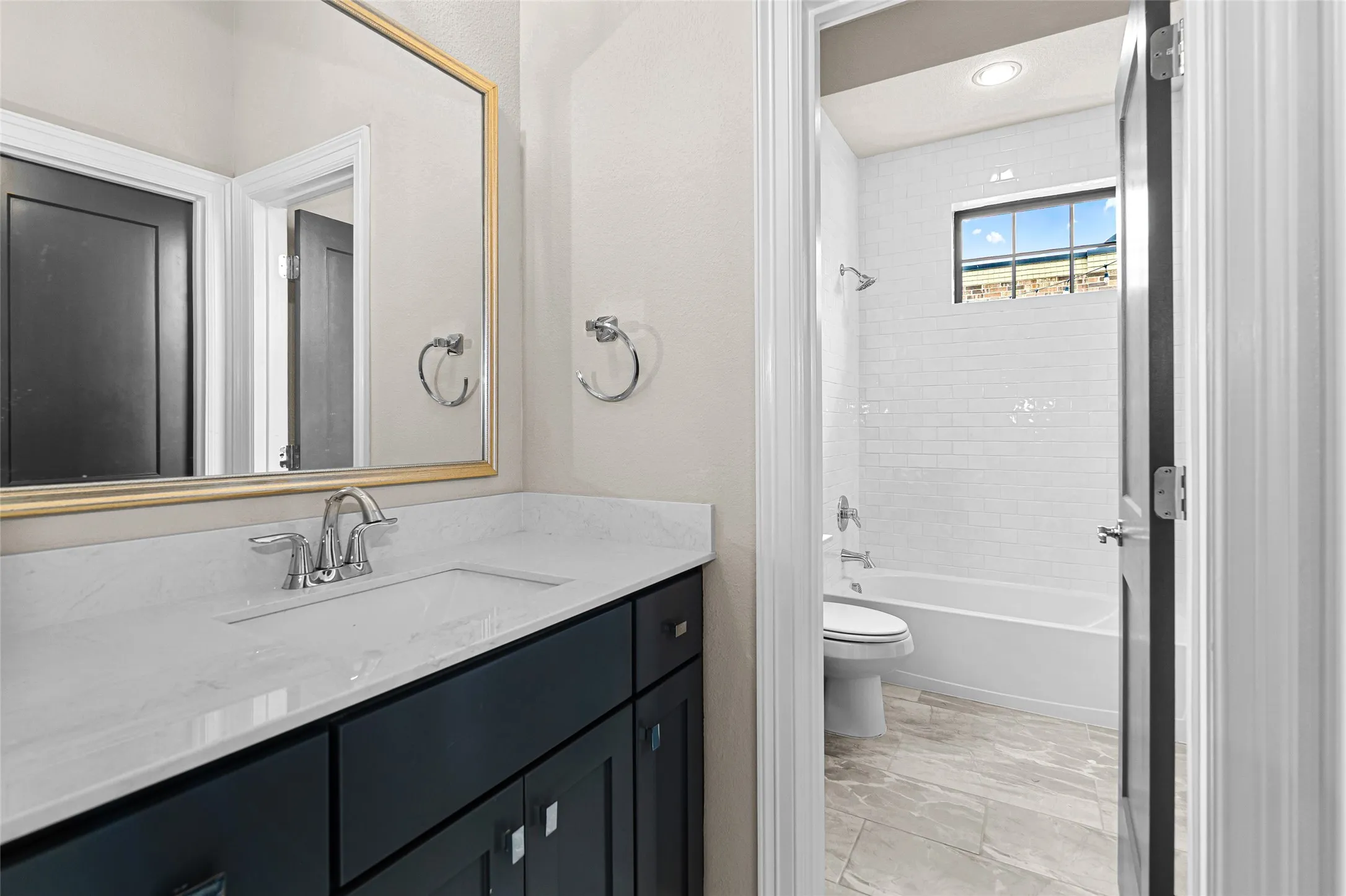 Modern bathroom vanity with a white countertop and undermount sink.
Jack and Jill Bathroom