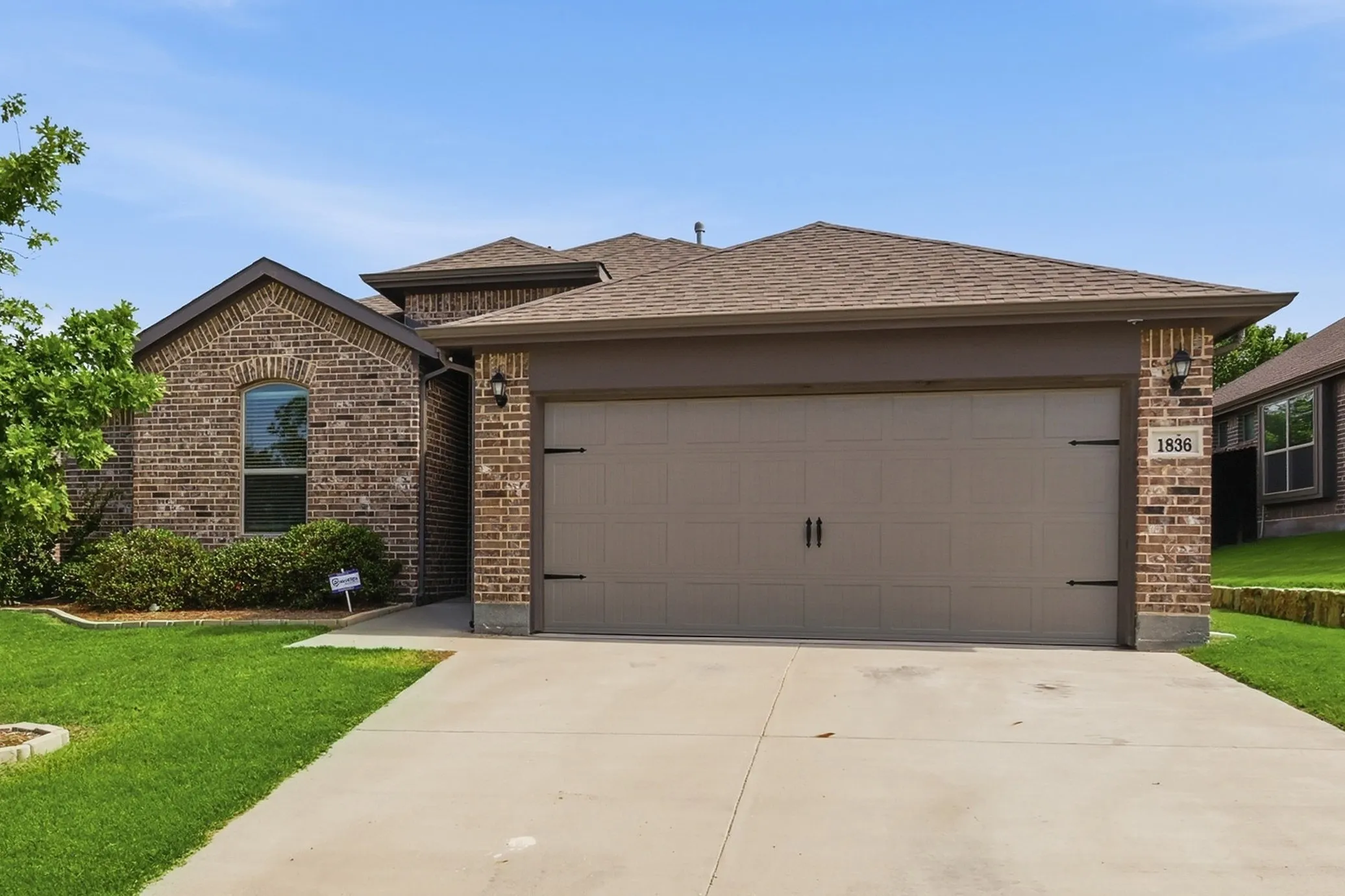 Brick exterior with a two-car garage