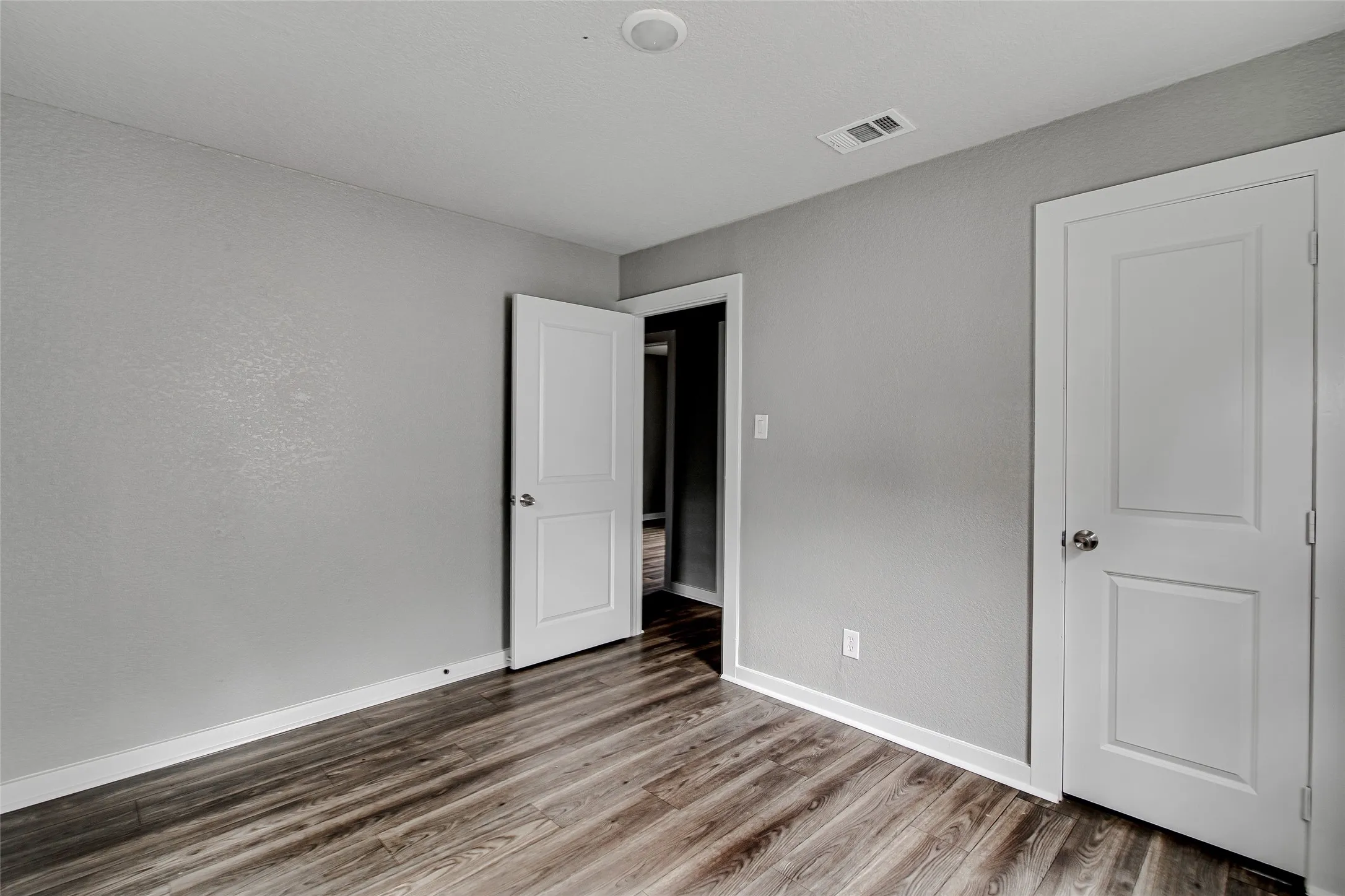 Neutral gray walls complementing wood-finish flooring