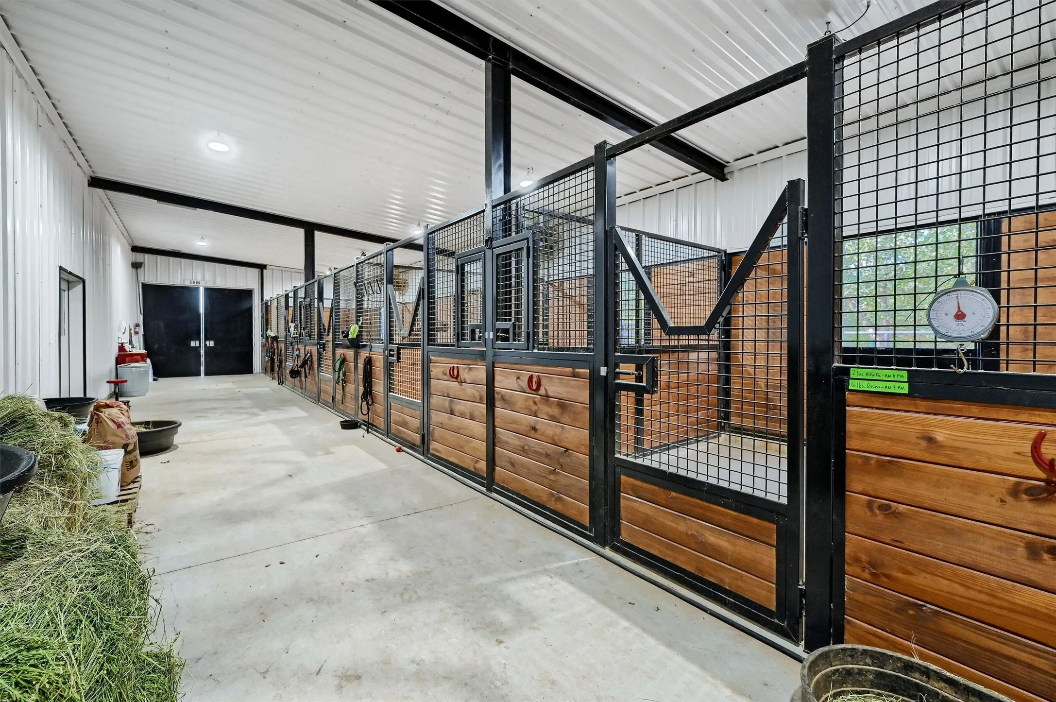 The 5-stall barn has a concrete alleyway, electric fans, and each stall has access to outdoors.