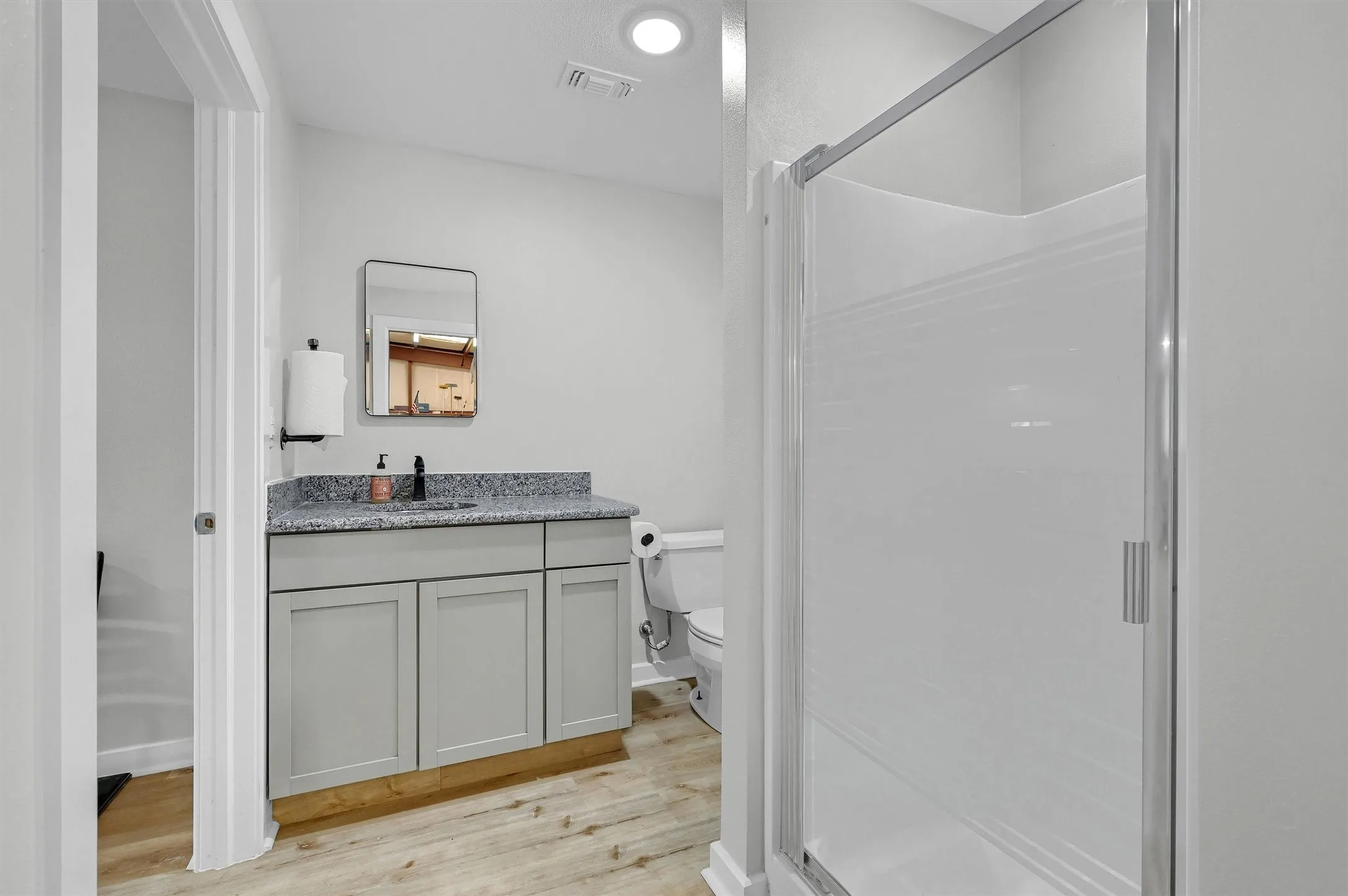 Shop-barn apartment bathroom has a large shower.