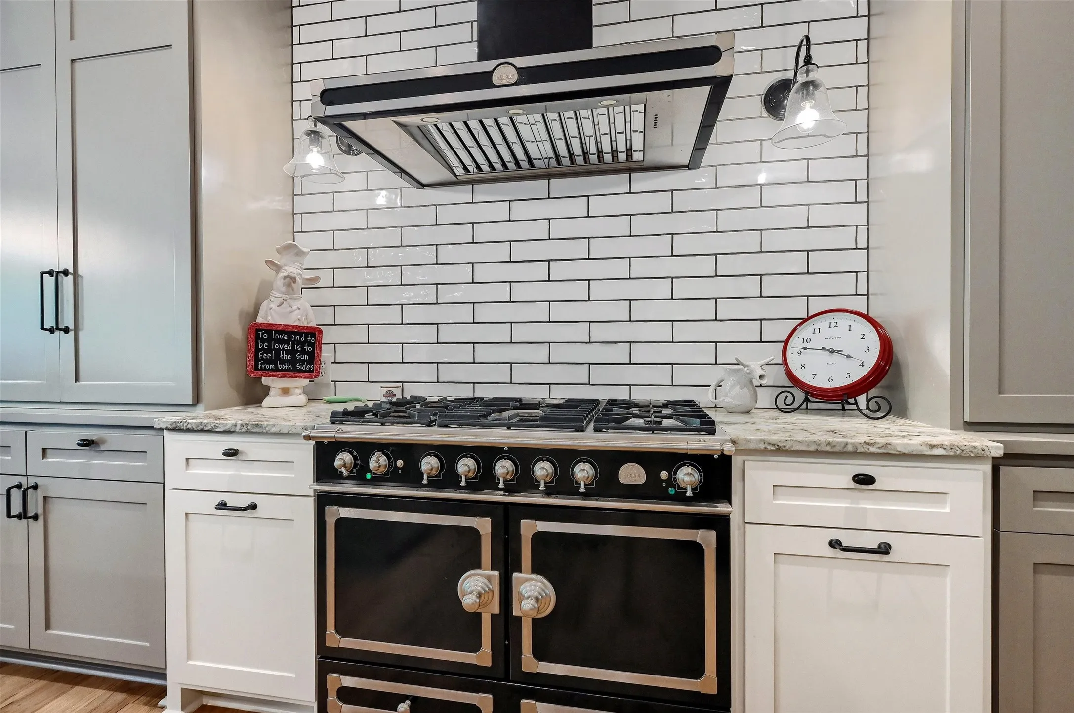 A large gas stovetop and dual ovens are just waiting for the cook in the household.