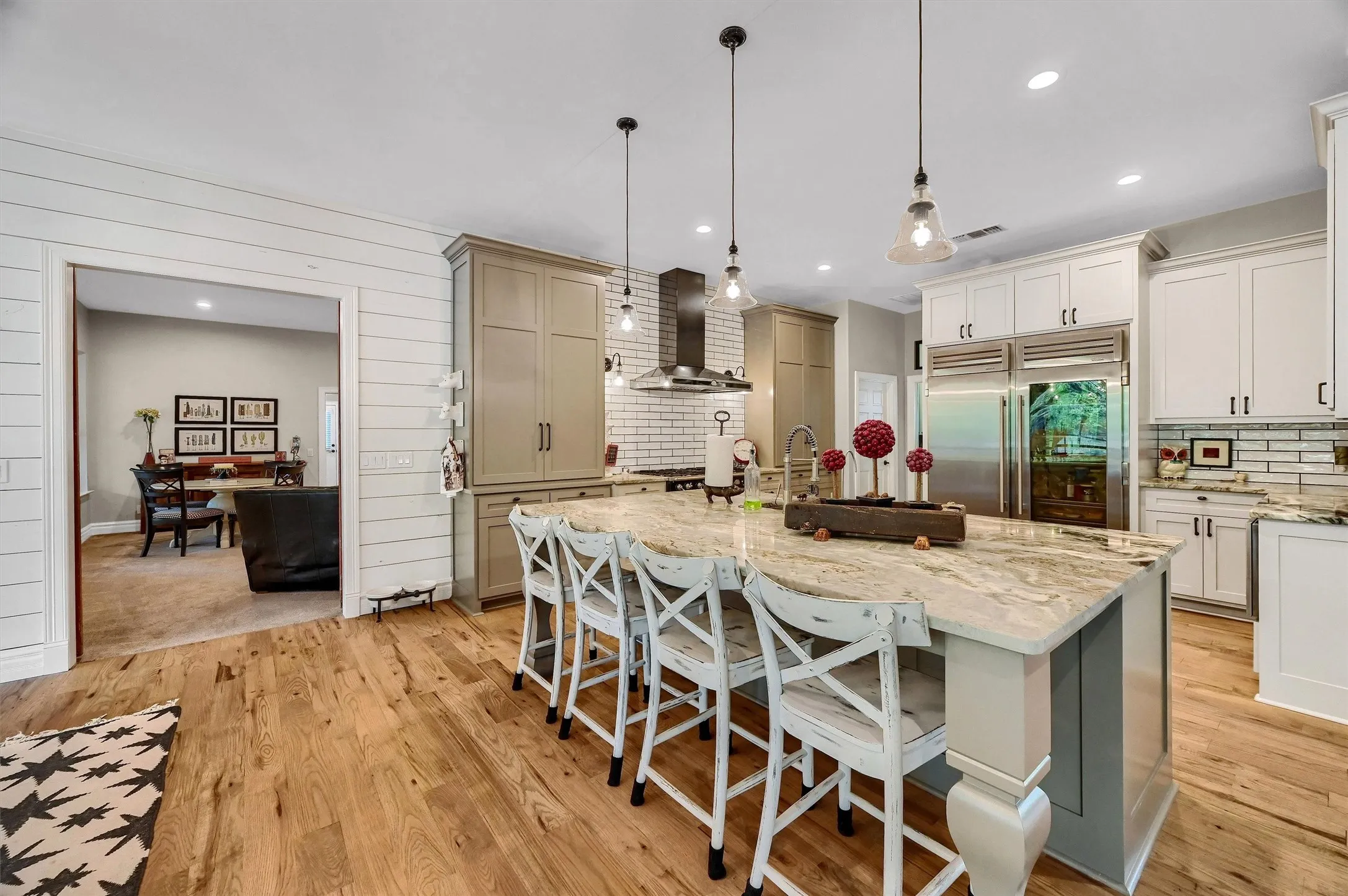 An eat-at island and stainless appliances, including a built-in refrigerator make the kitchen a chef's delight.