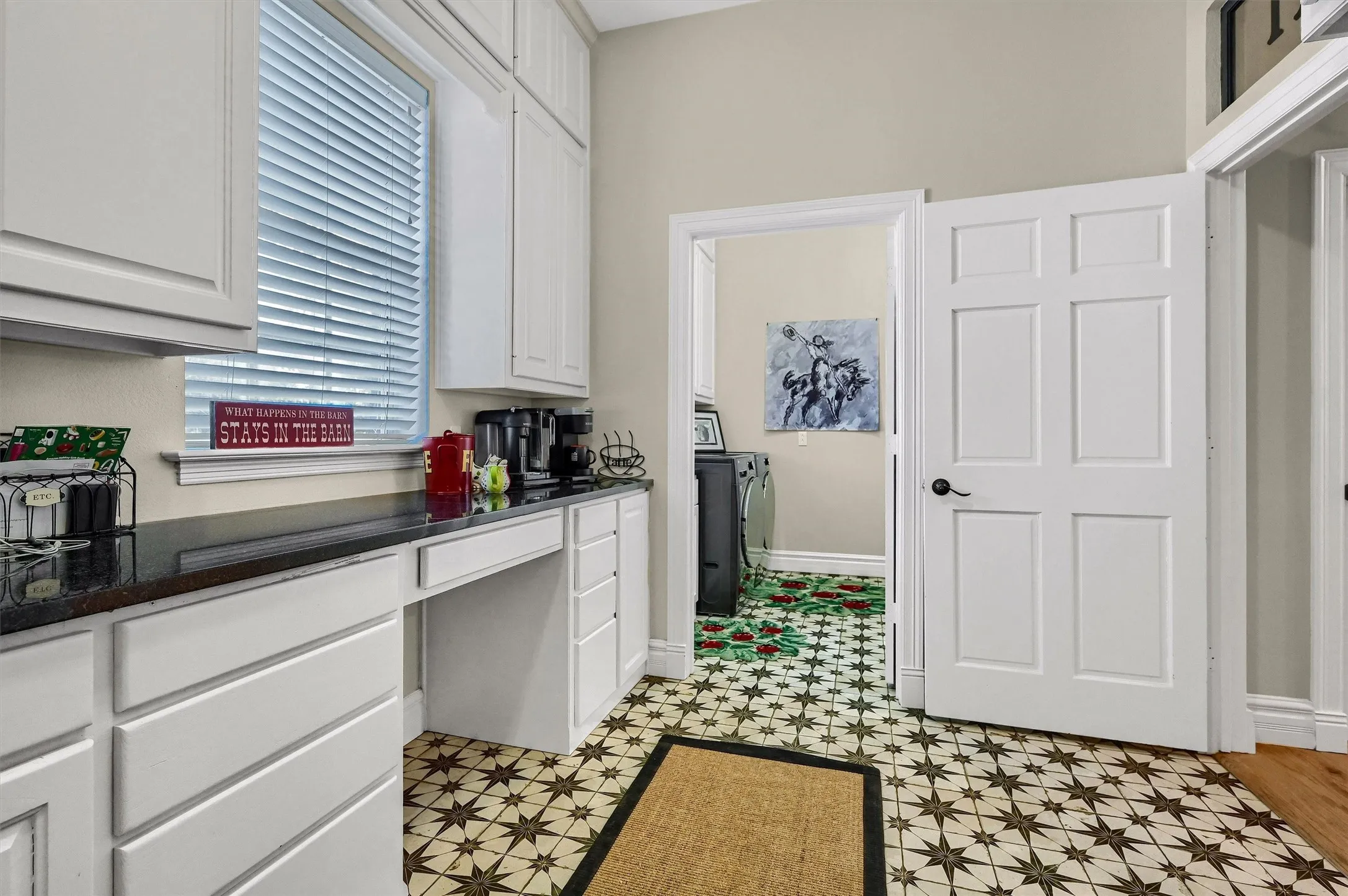 Writing desk in hallway leading to the laundry room.