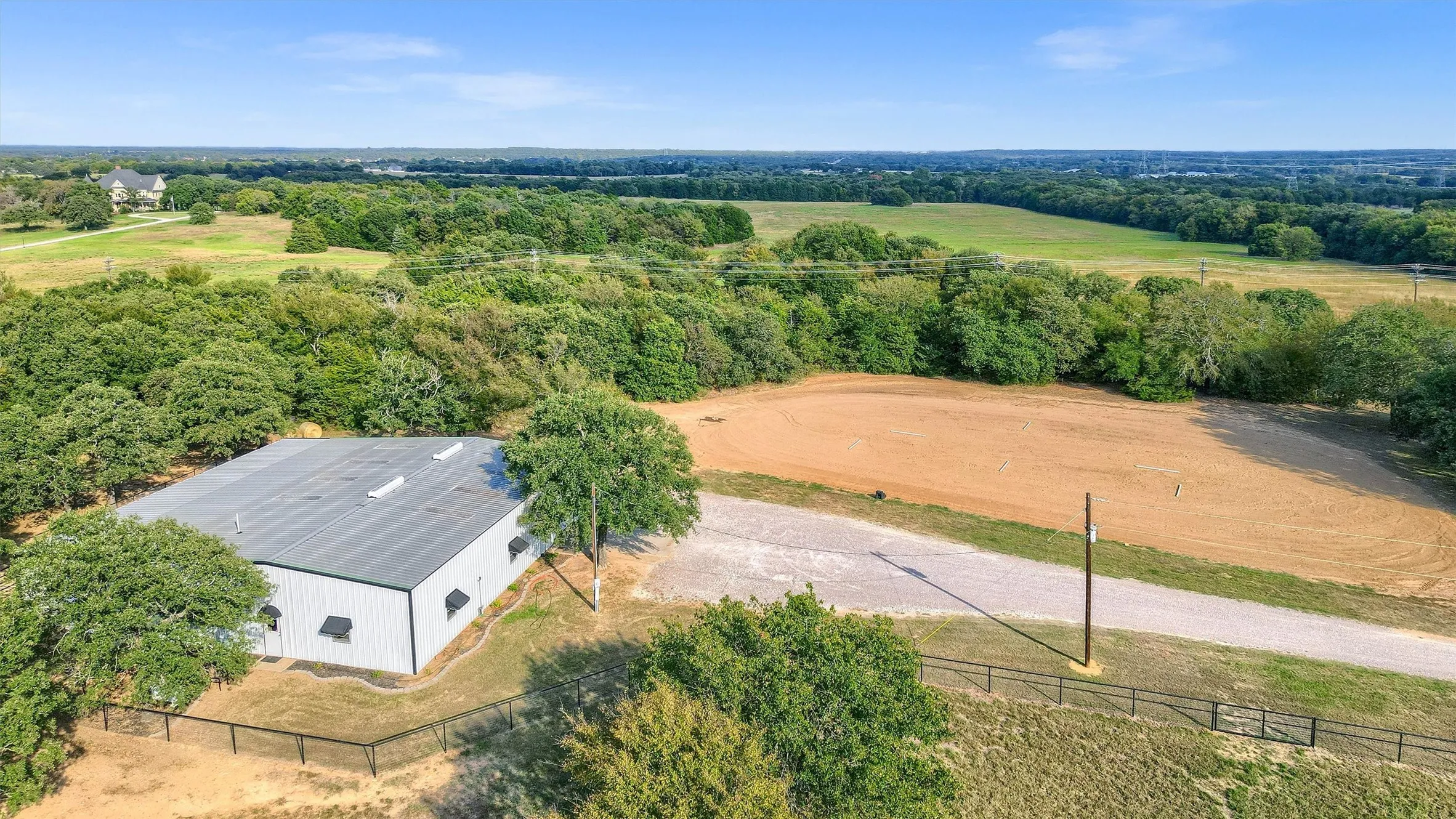 Aerial view of the shop-barn and the adjacent outdoor riding arena.