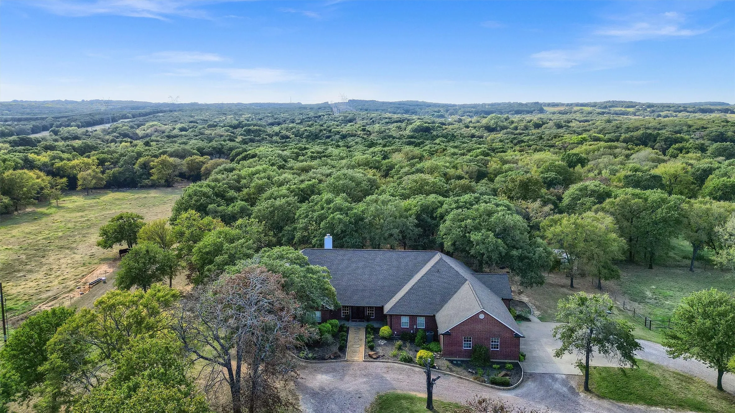 The custom home is private, nestled amongst towering oak trees - not visible from the road.
