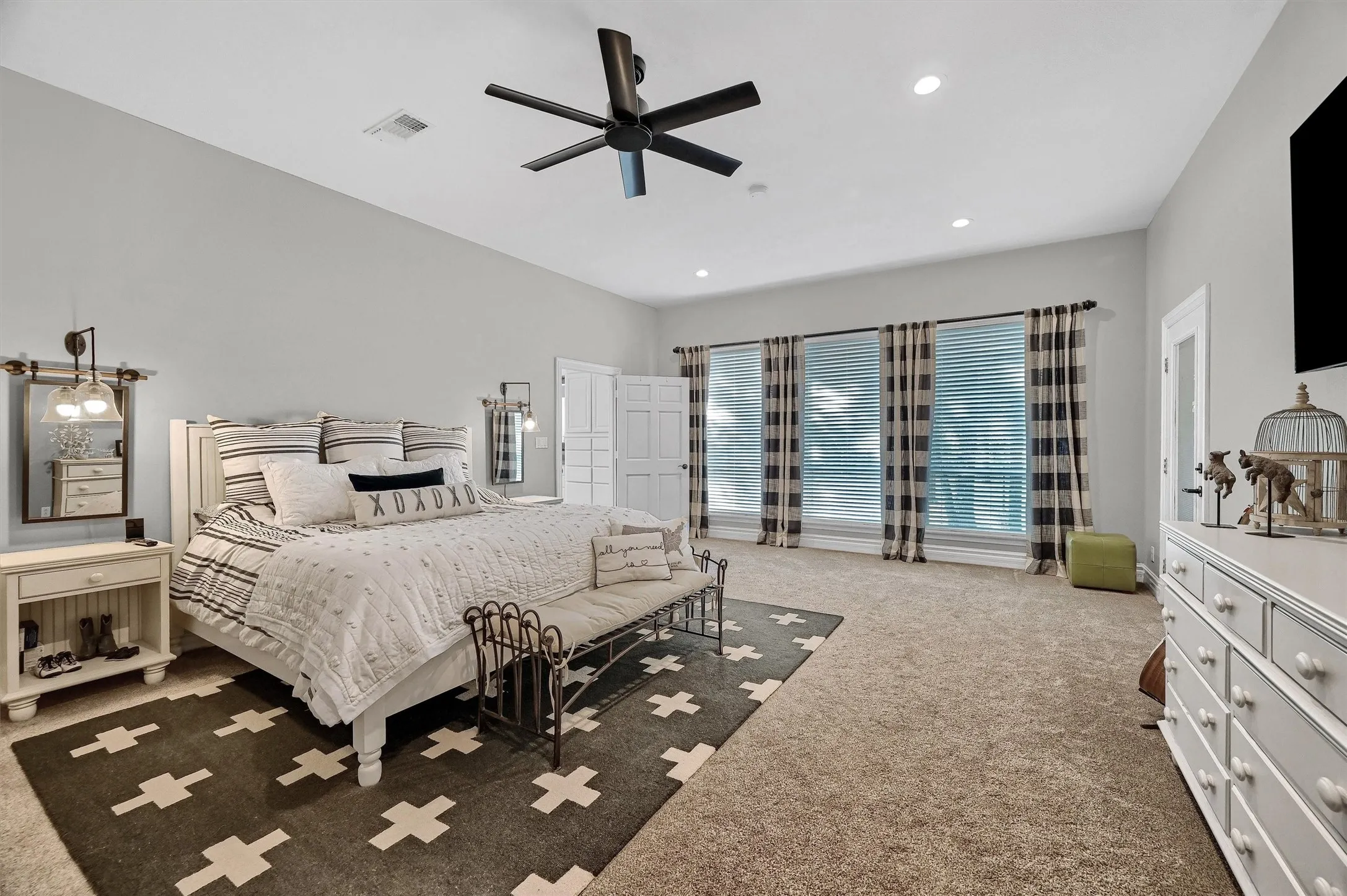 Spacious primary bedroom  has direct access to the screened porch.