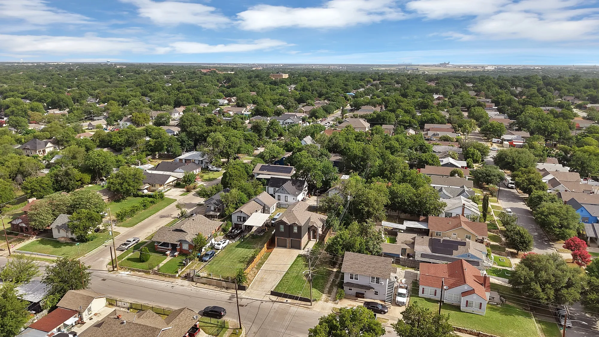 Residential street featuring established homes with mature tree canopies