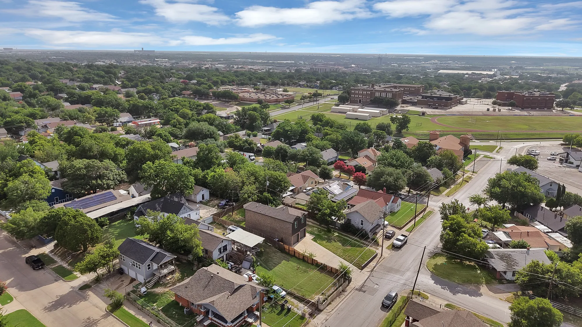 Aerial perspective showcasing a residential neighborhood with mature trees