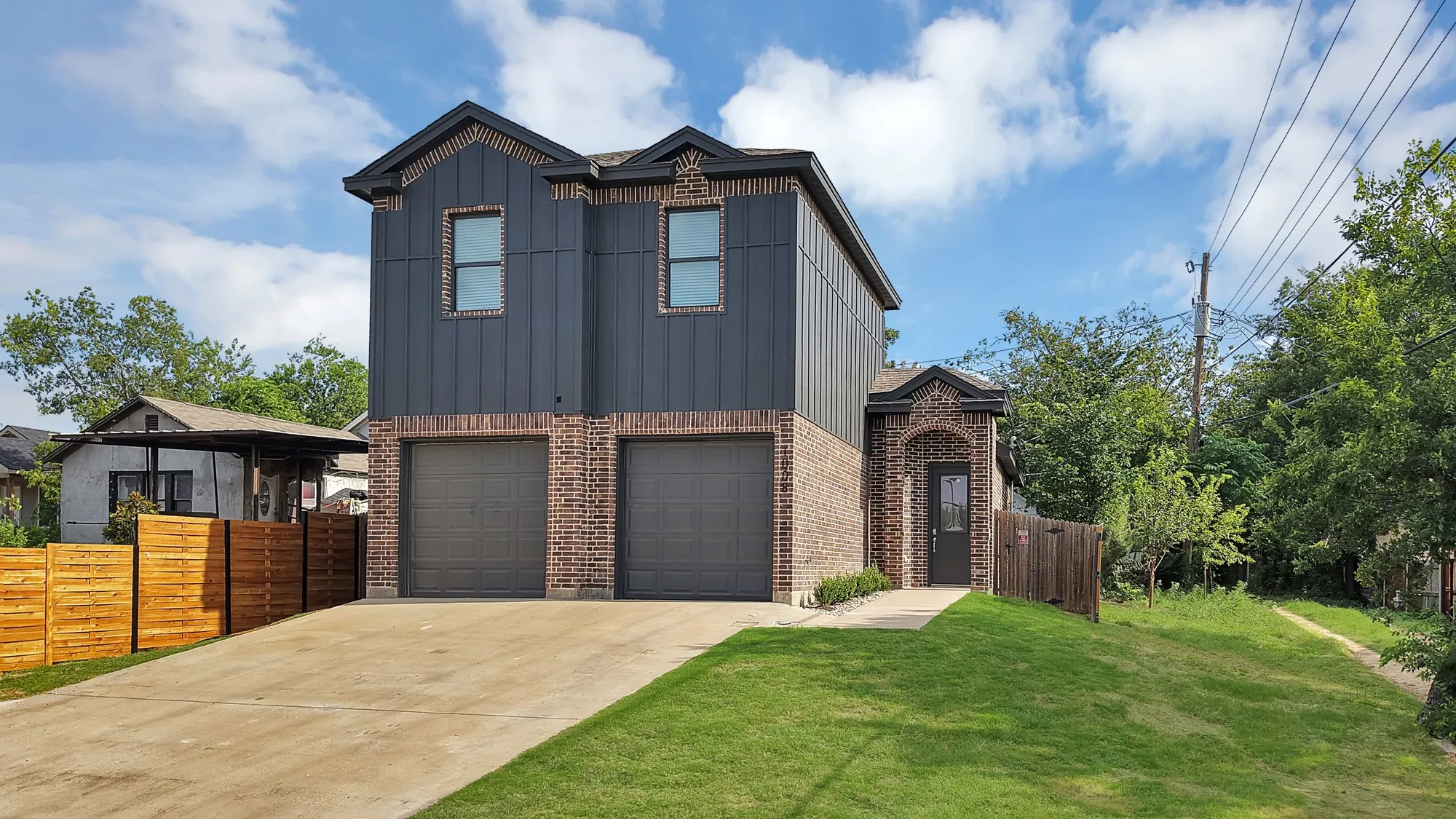 Contemporary exterior with brick and vertical panel siding