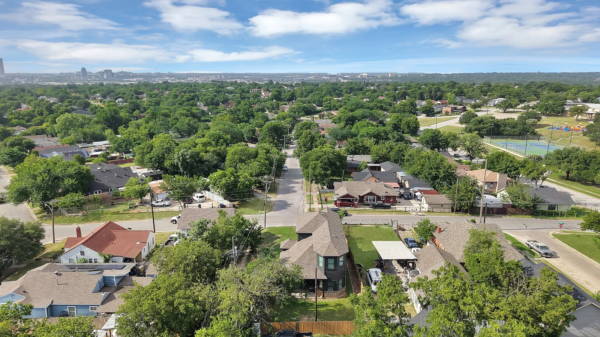 Aerial perspective showcasing a residential area with mature tree coverage