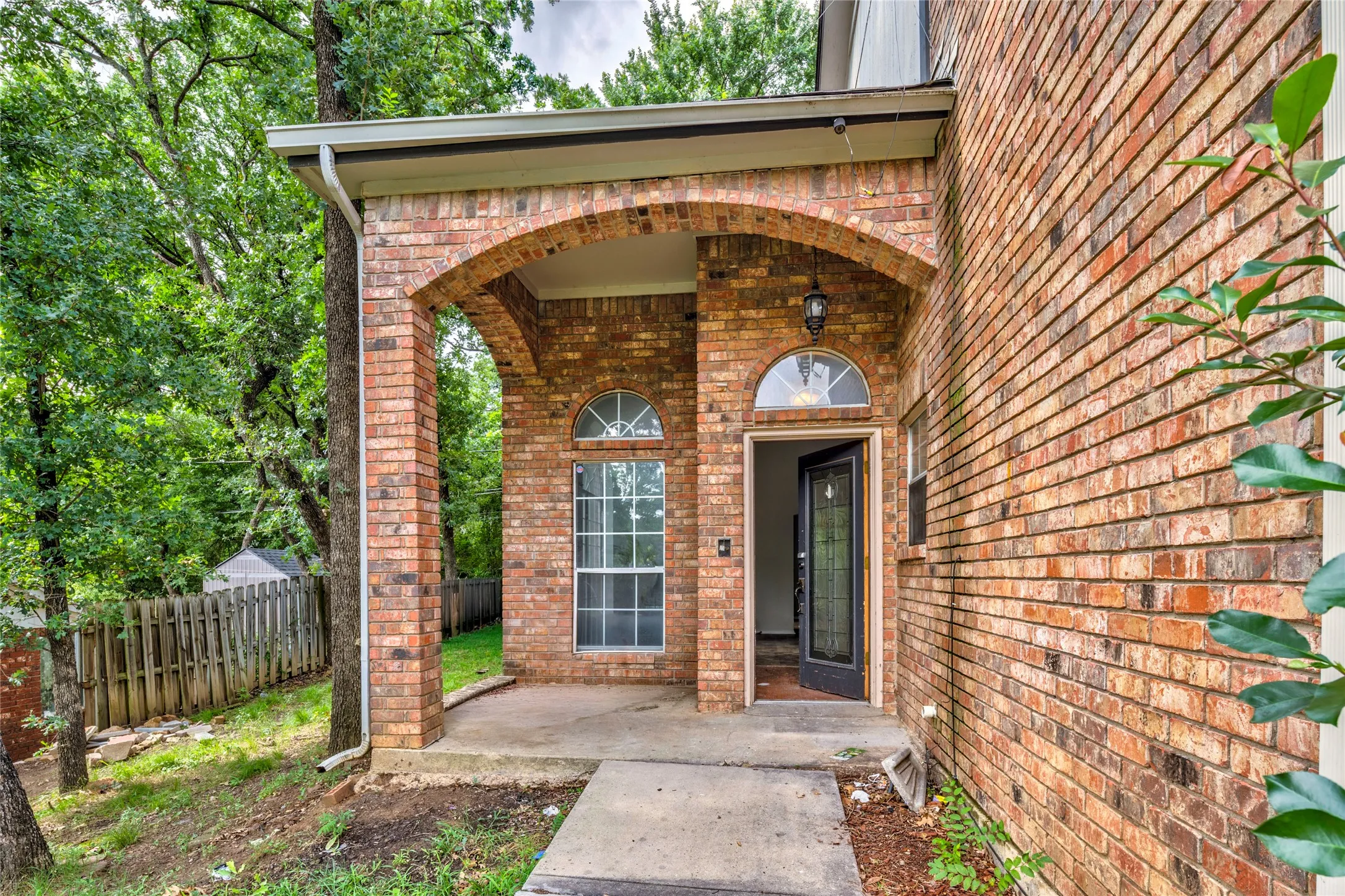 Brick exterior with an arched entry porch