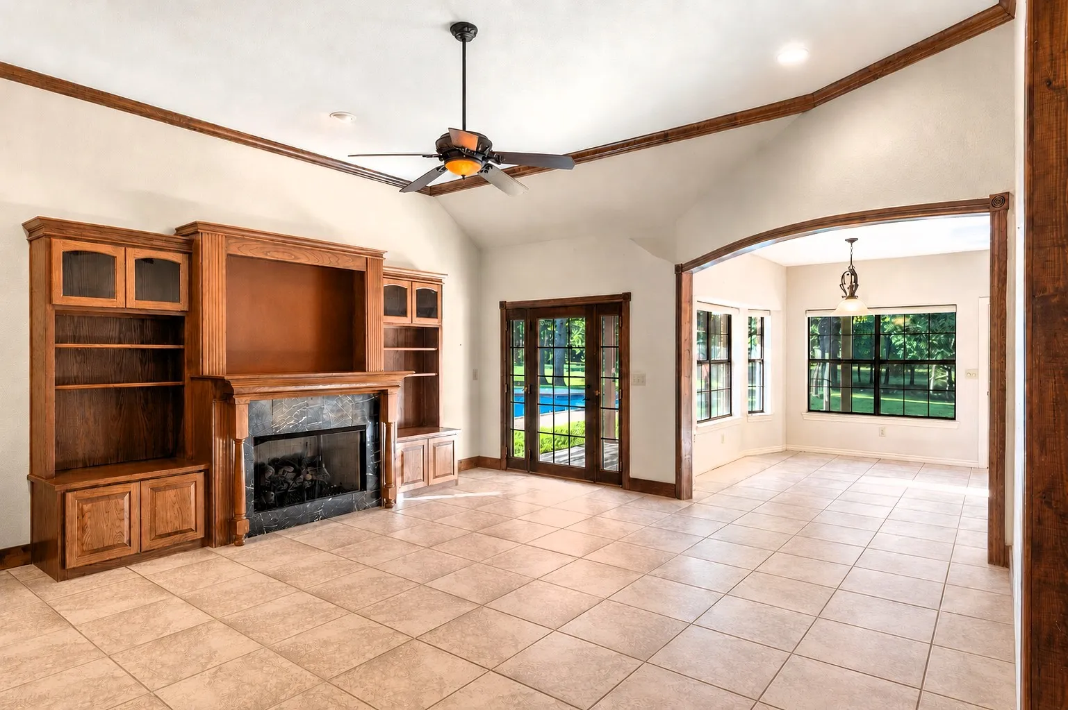 Notice the pool's view from the den's French door.  Add TV, couch,lounge chairs, dining table and Voila!!