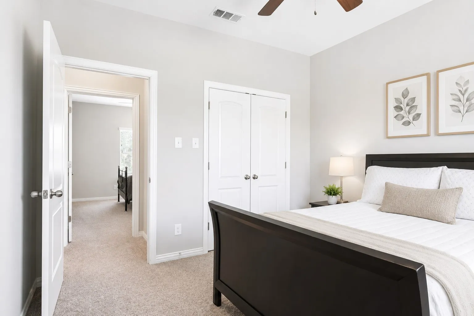 Carpeted room featuring light gray wall paint, a ceiling fan, and double-door closet