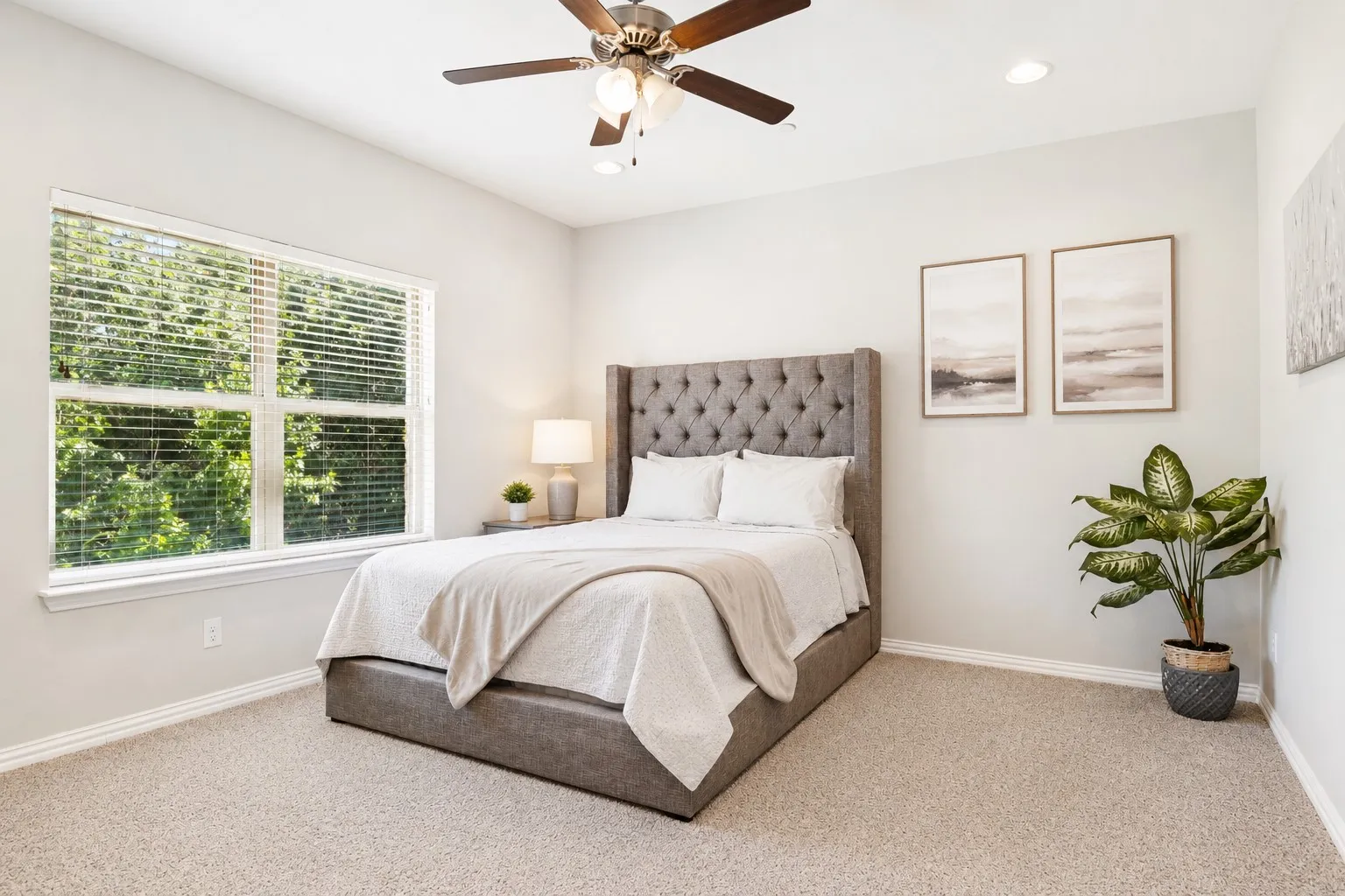 Light-filled room featuring a large window, recessed lighting, a ceiling fan with integrated lighting, and neutral carpeting