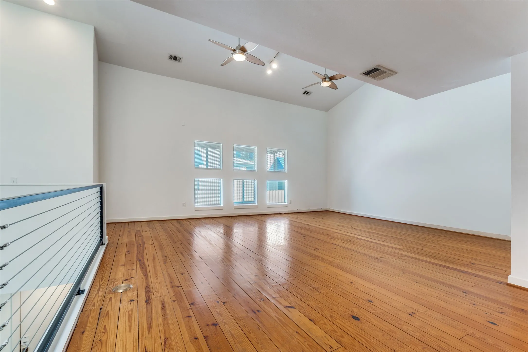 Light from large windows and vaulted ceilings in living area.