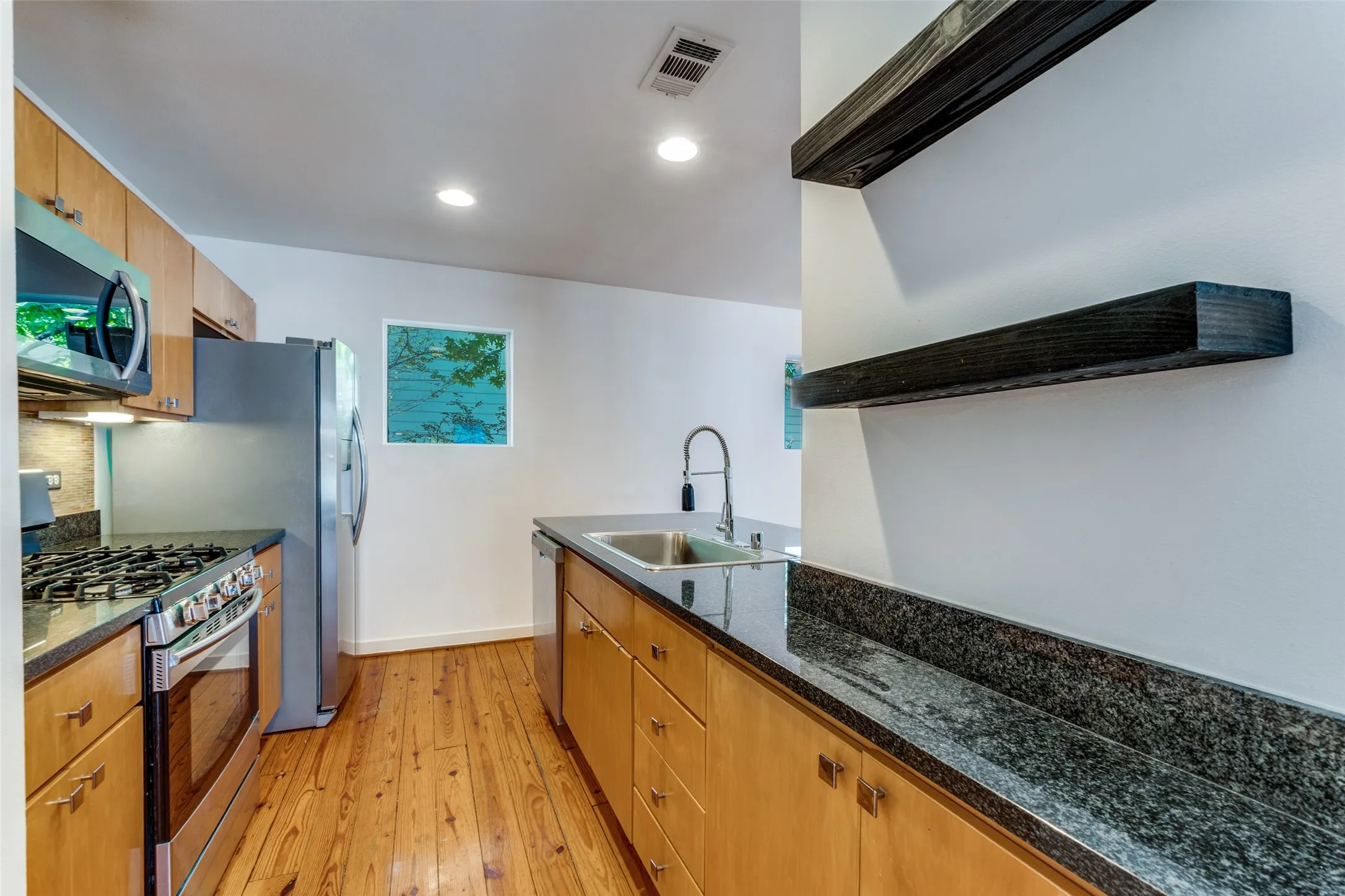 Sleek wood finishes and design in kitchen.