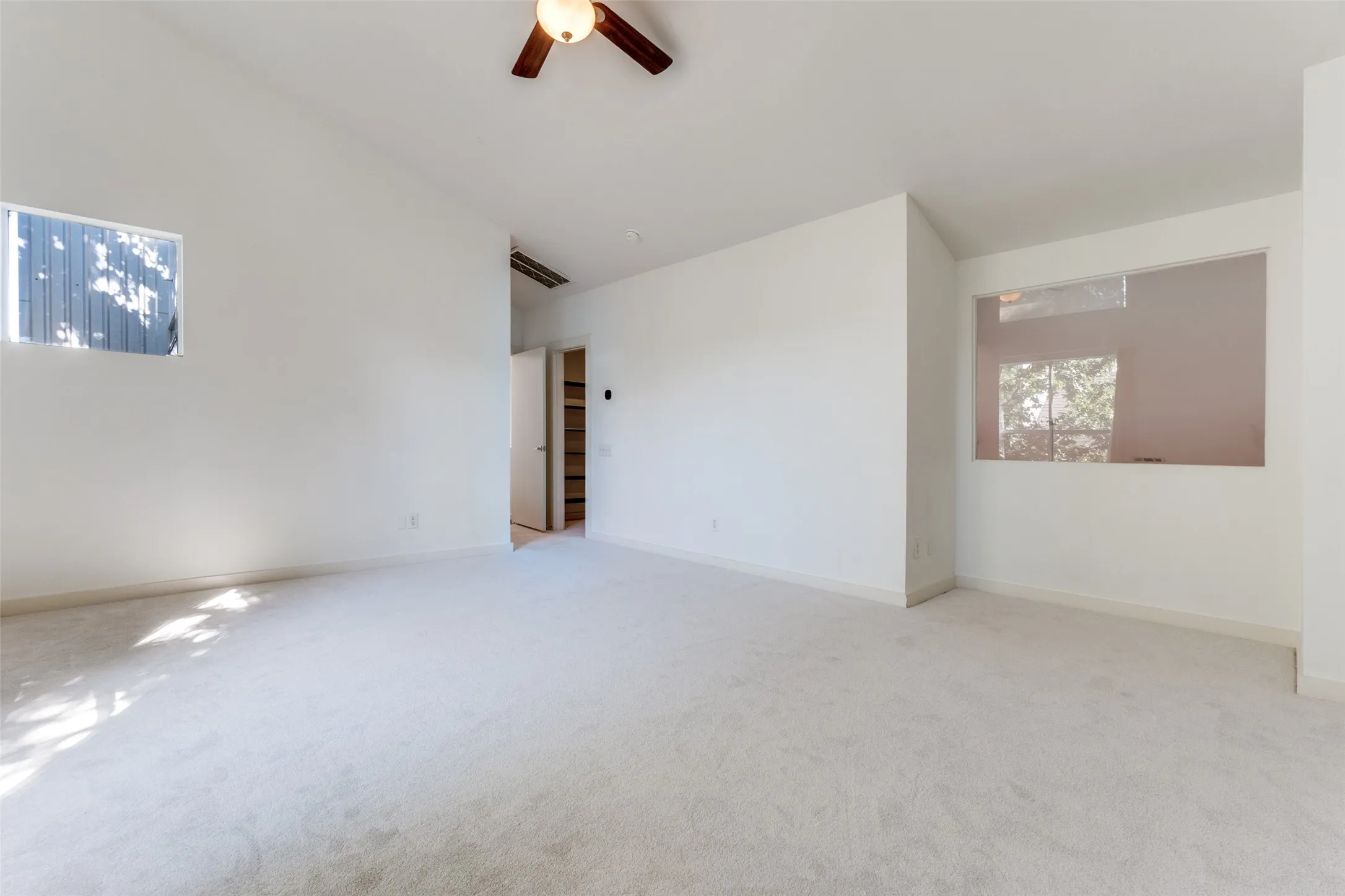 View primary bedroom including extra nook and entrance to closet.