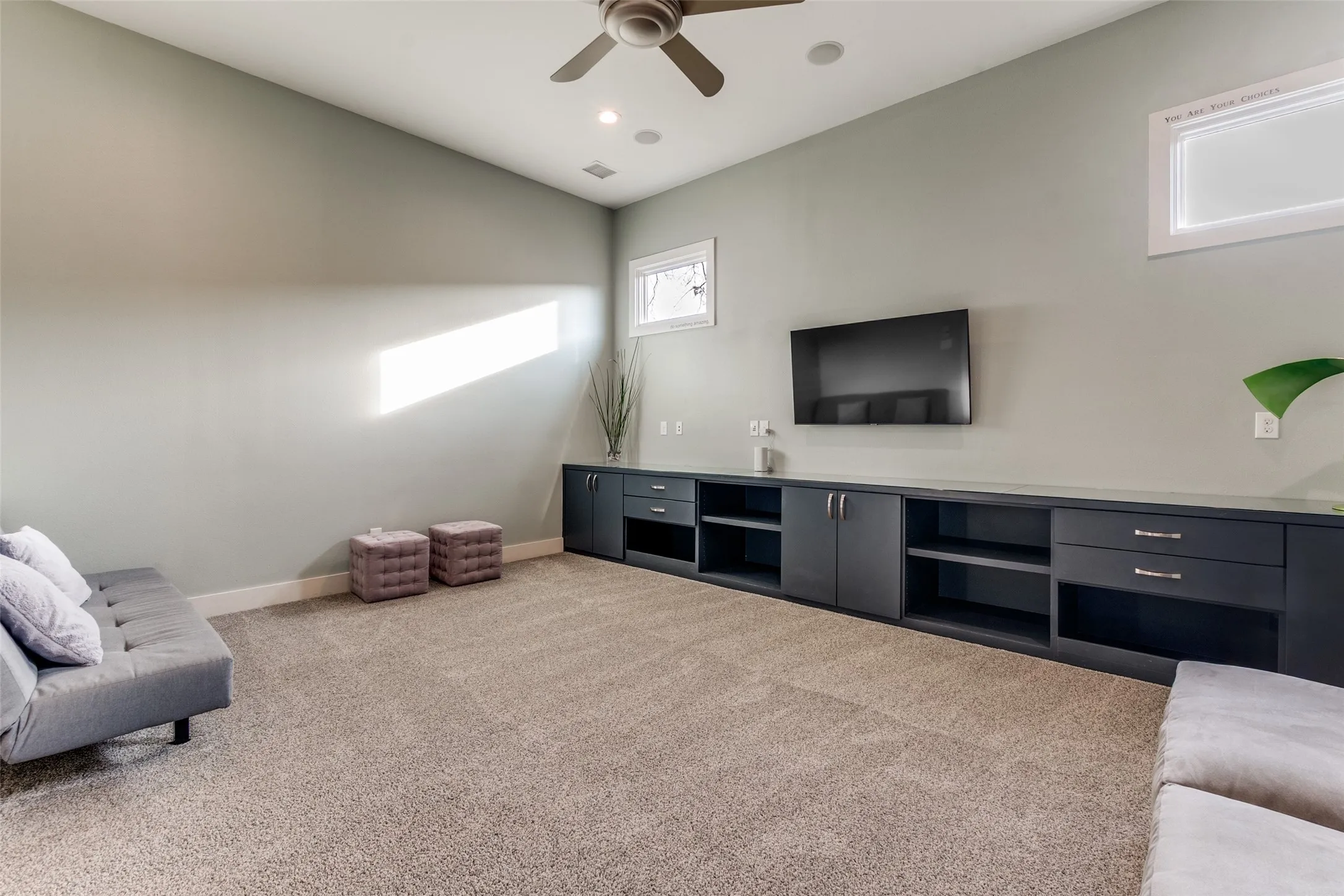 Spacious playroom featuring a vaulted ceiling with a ceiling fan, recessed lighting, and soft carpet flooring