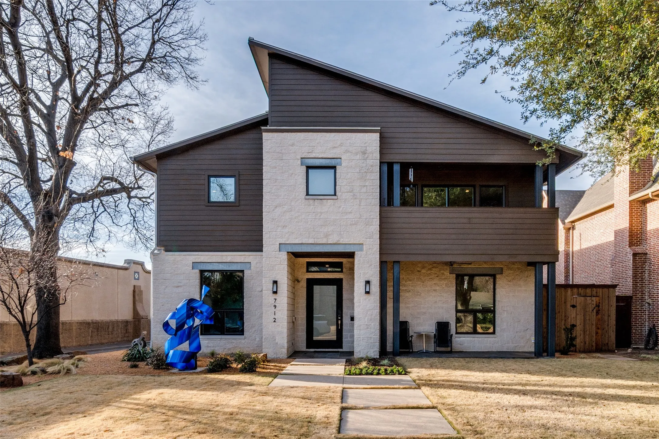 Modern facade featuring stacked stone and horizontal siding