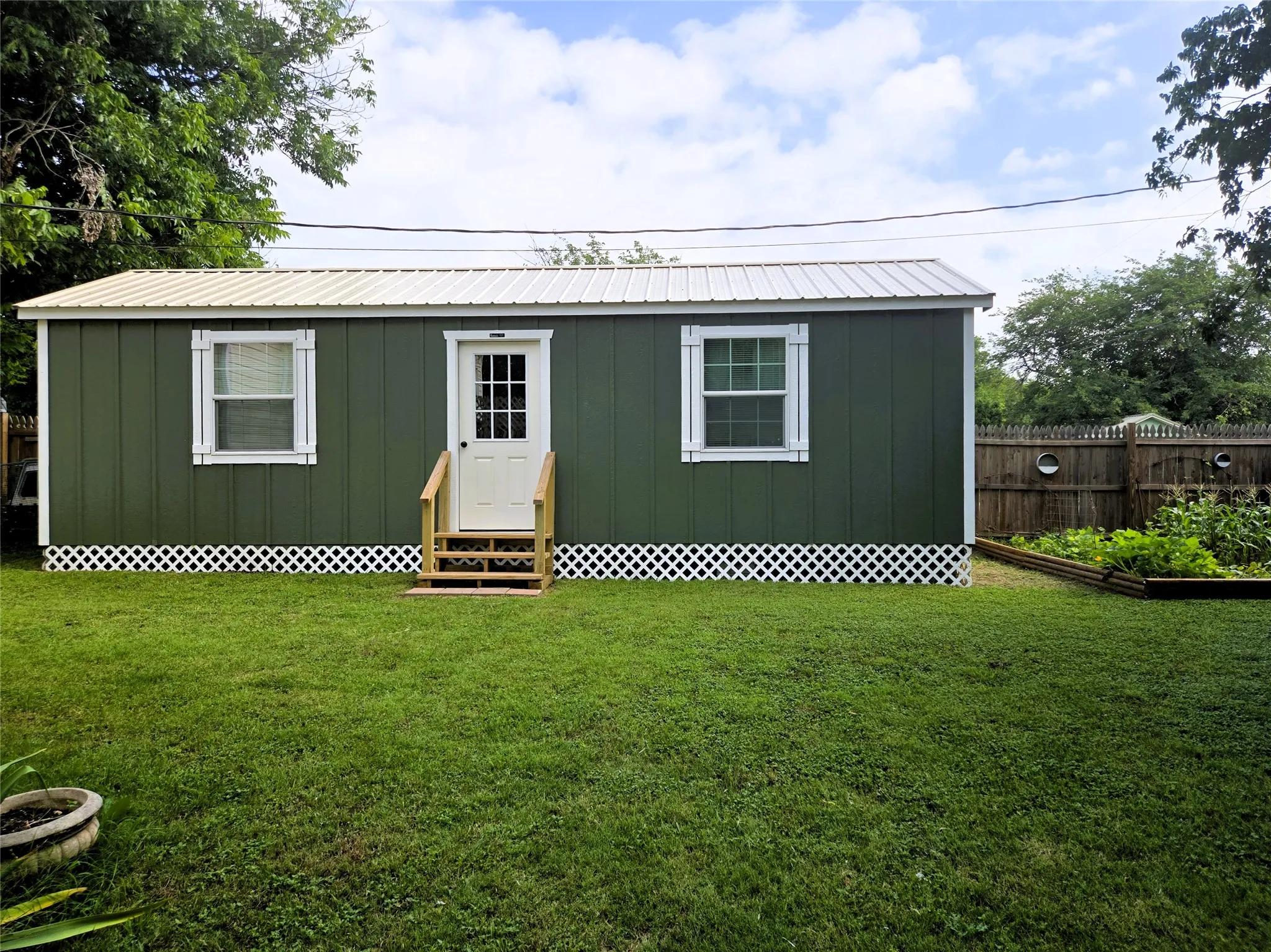 Front entrance of She shed and back yard.
