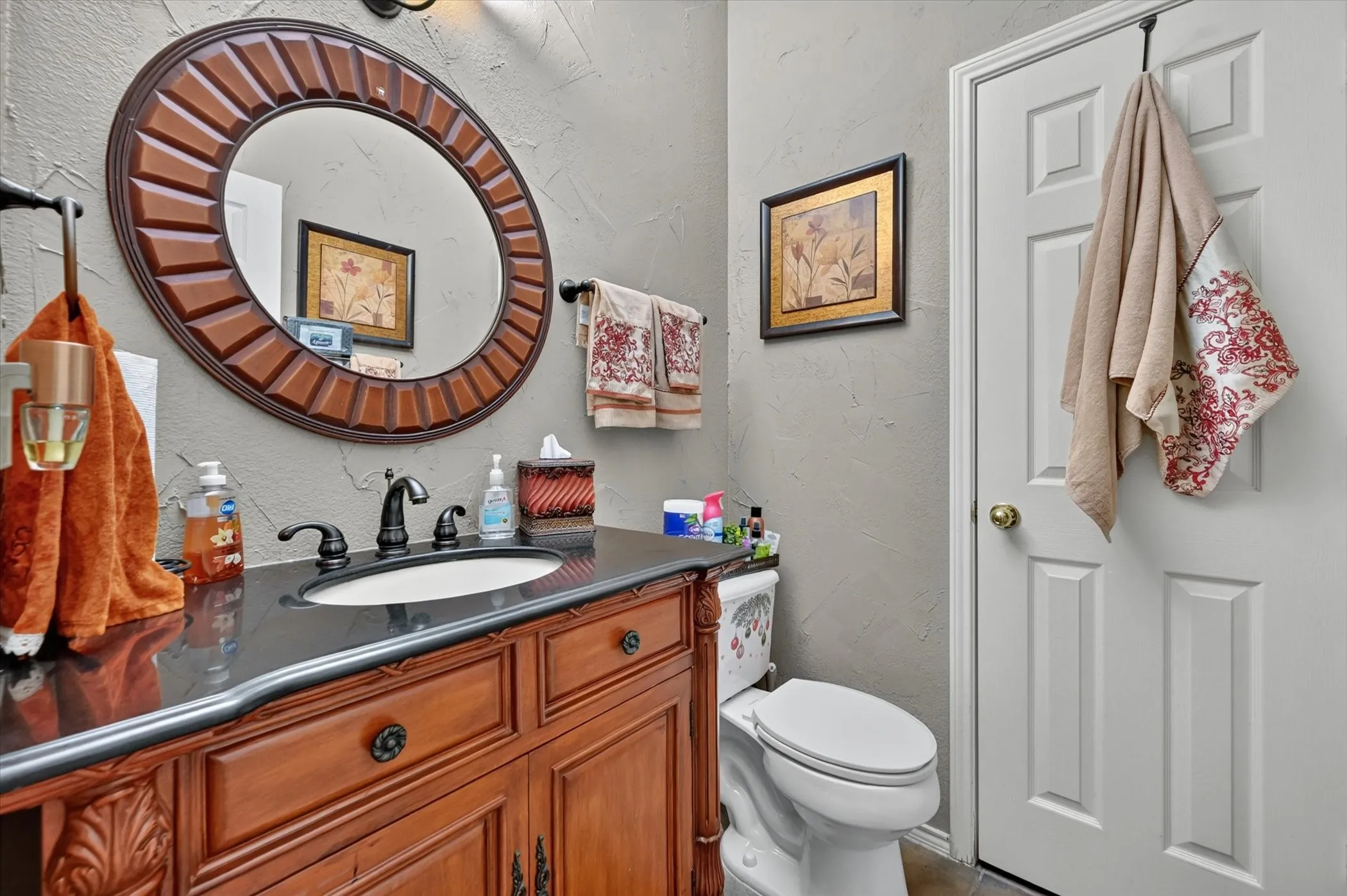 Downstairs Bath -Vanity with a dark countertop and undermount sink, complemented by oil-rubbed bronze fixtures