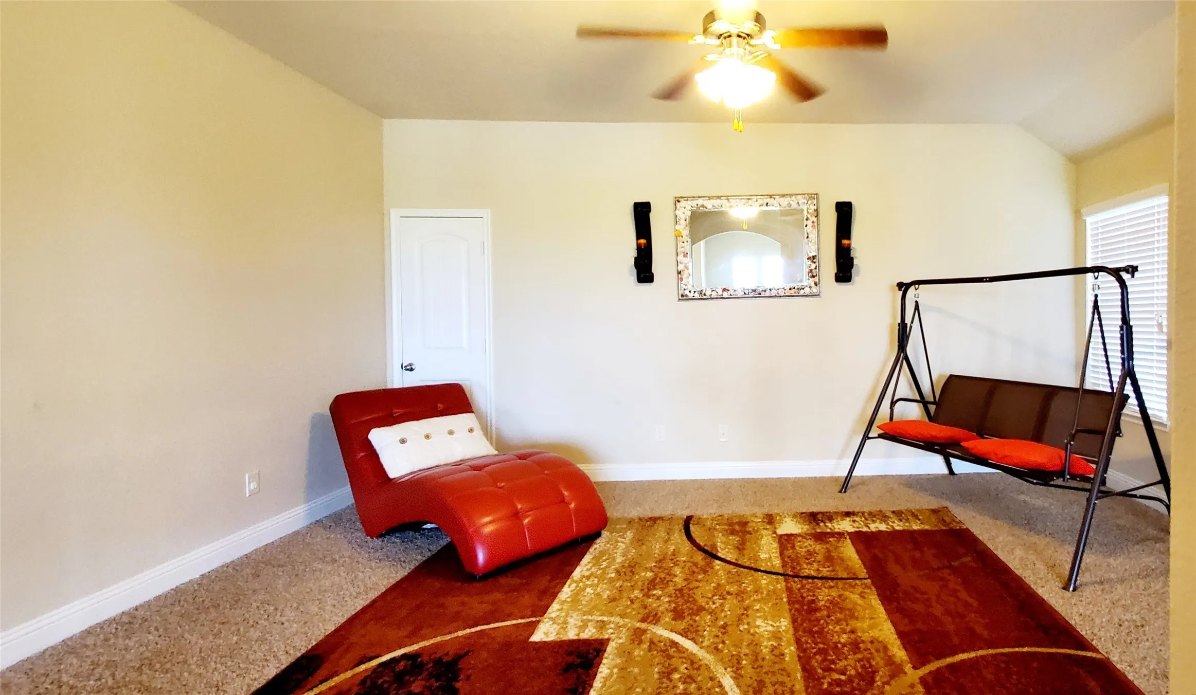 Spacious room with neutral wall tones and a textured carpet
