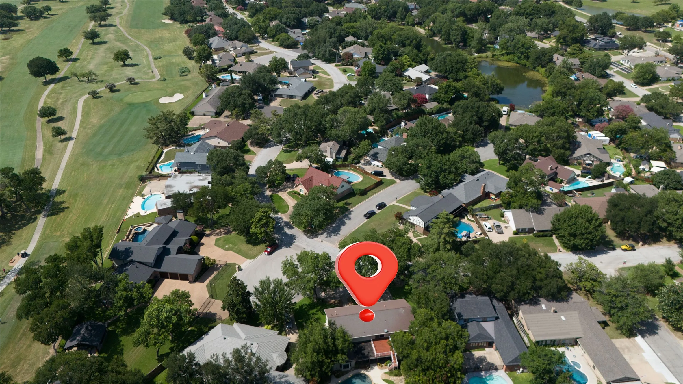 Aerial view of the back of the home over looking at neighborhood and Diamond oaks Country Club with mature well maintained pecan trees surrounding the home