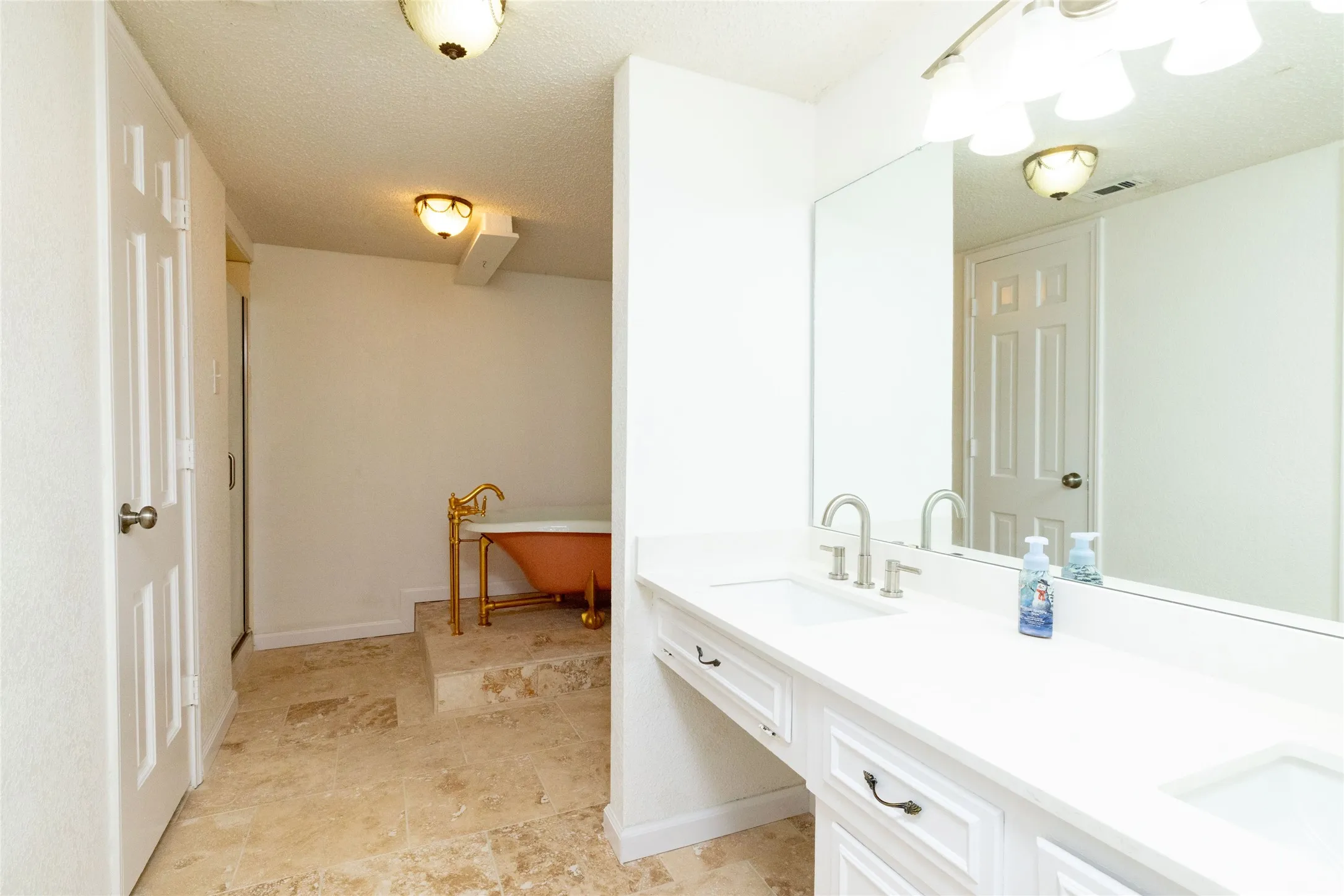 12.8 x 13.3 Downstairs master Dual vanity with white cabinetry and integrated sinks