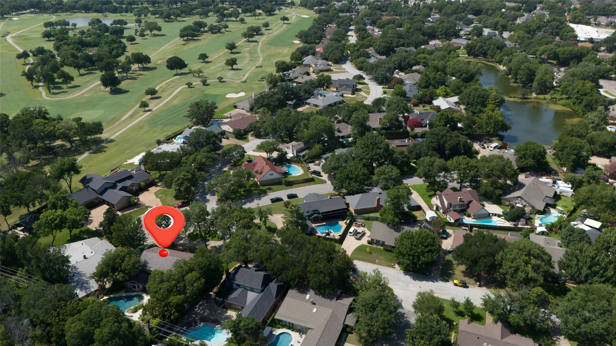 Aerial perspective showcasing a residential area with proximity to Diamond Oaks Members only golf course and Country Club and a natural pond in the center of the neighborhood