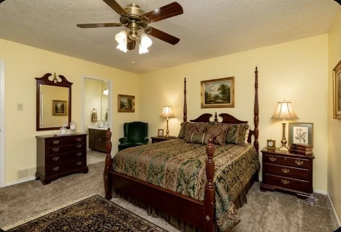 Spacious 14.6 x 13.3 upstairs bedroom with ensuite bathroom, 3 closets featuring neutral carpeting and light-colored walls
