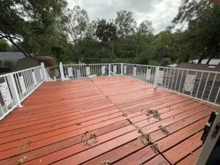Spacious 15.7 x 17.7 outdoor deck featuring red-toned wood flooring and white railings, over looks the inground pool and the Nature Walking and biking trails