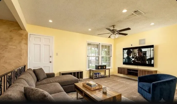 Upstairs Carpeted upstairs living area 15 x 15.4f eaturing recessed lighting, a ceiling fan, and multiple windows