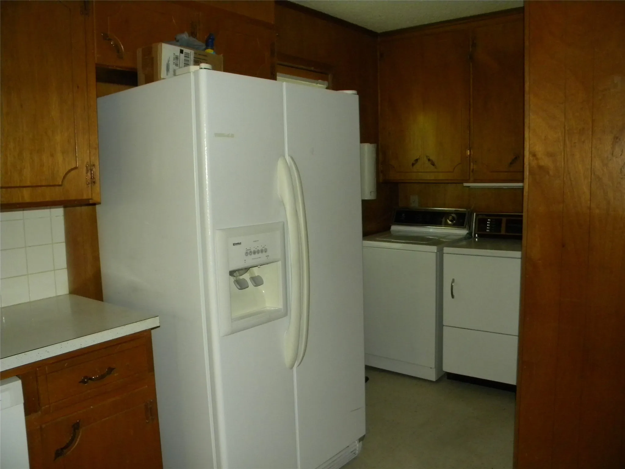 Side by Side Refrigerator and view into utility/laundry